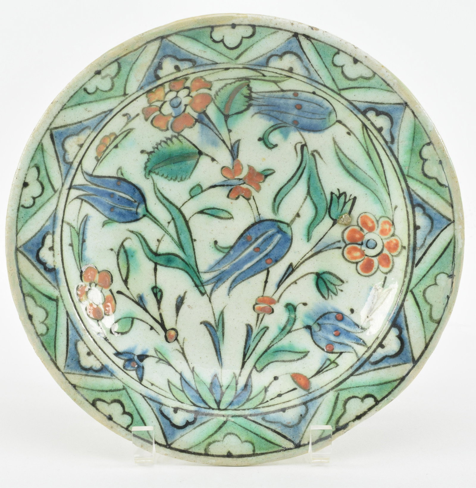 Pottery plate. Ottoman Turkish. Iznick ware, from: Pottery plate. Ottoman Turkish. Iznick ware, from Kutahya, Syria. 19th century. Rim fritted and age lines. 10in diameter. Provenance: Esin-Engin Ansay Collection.