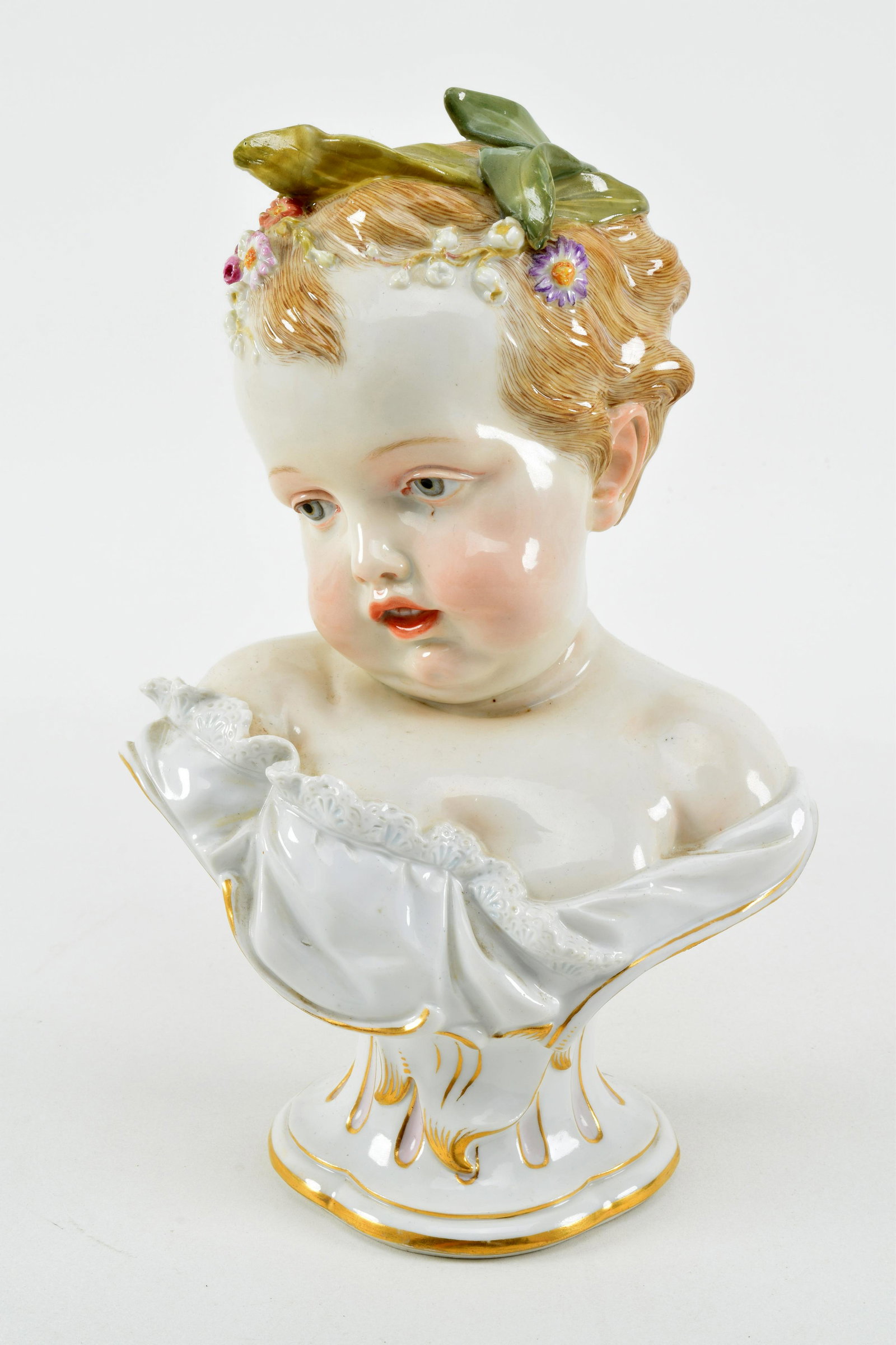 19th century Meissen porcelain bust of a young girl. 1: 19th century Meissen porcelain bust of a young girl. 1 leaf in her hair repaired. Back of bust has an overpaint repaired chip at base. 9.5in high.