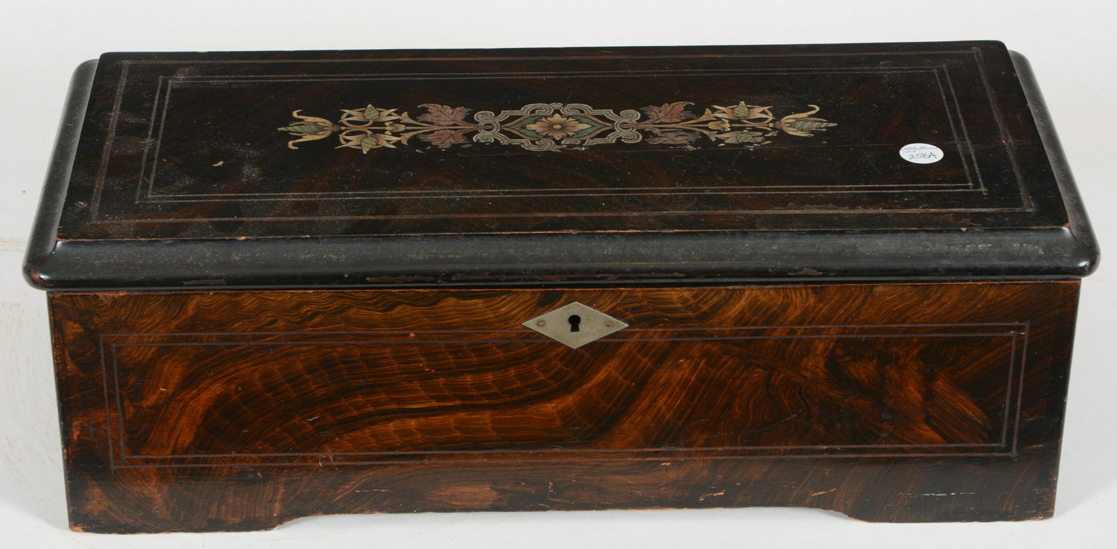Swiss grain painted 12 airs music box. Lithographed: Swiss grain painted 12 airs music box. Lithographed play card inside of lid. 9.25" barrel. 6in H x 18 W x 8.5 D. Wear to exterior. Working condition.