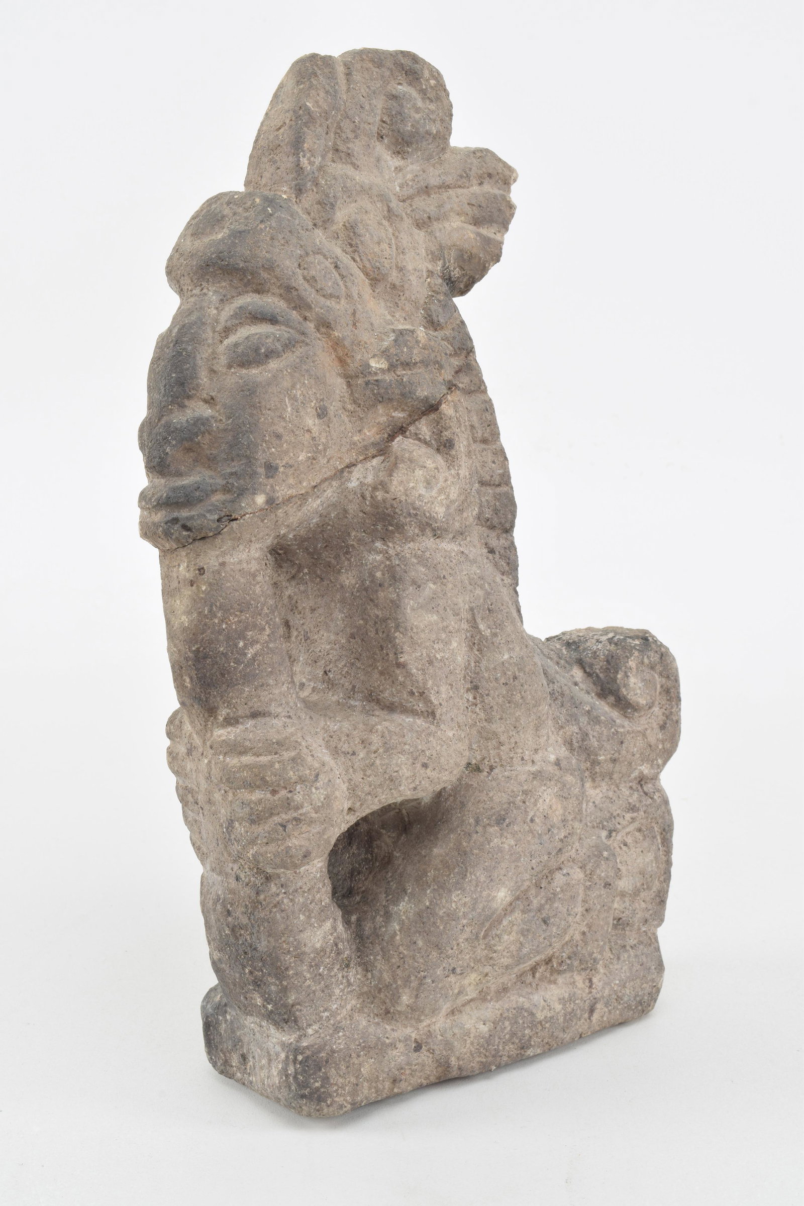 Pre-Columbian carved grey stone figure with crowned: Pre-Columbian carved grey stone figure with crowned crest. Head reattached. Probably Vera Cruz. 10.25in high.