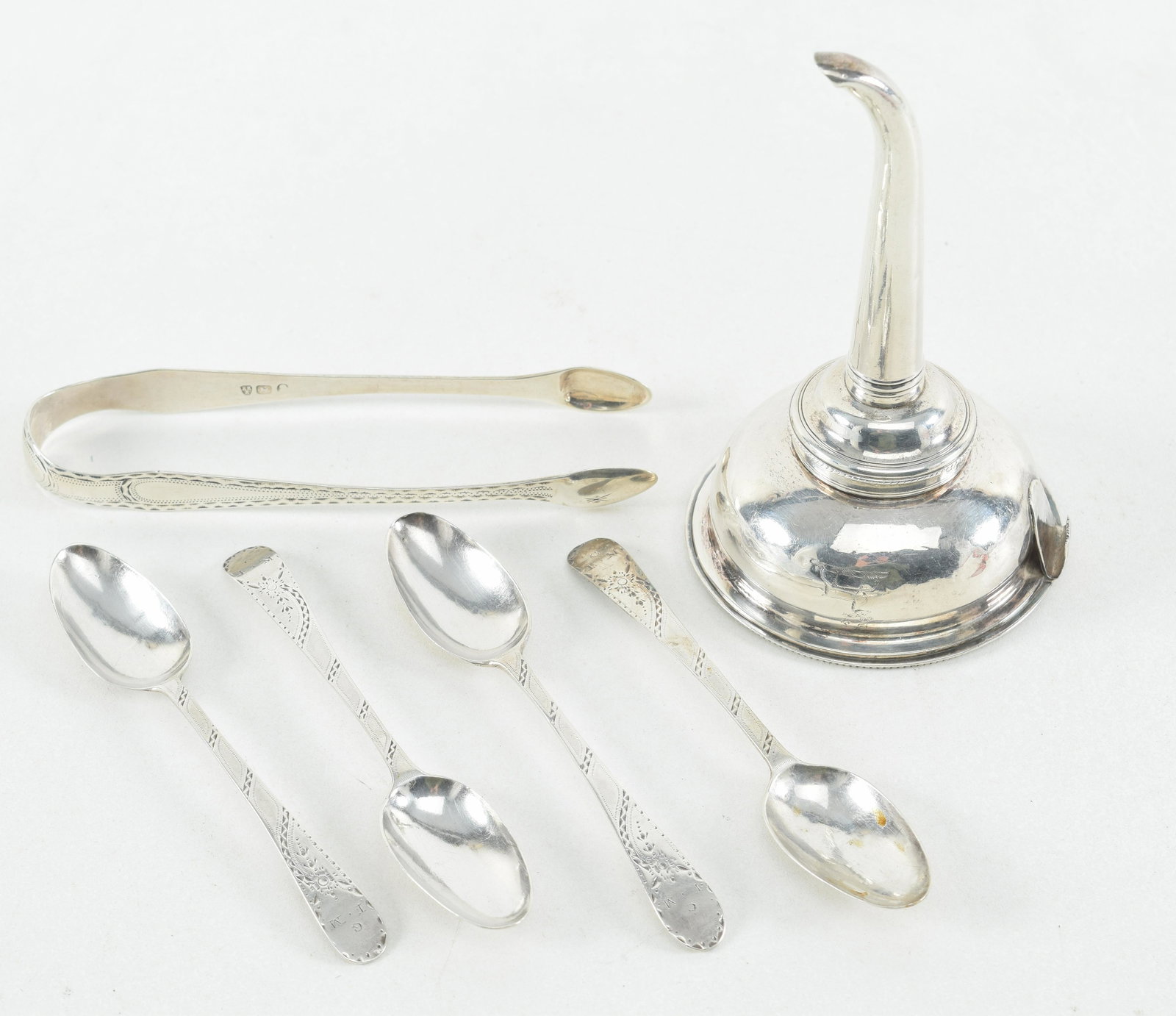 Georgian silver items, sugar tongs, 4 coffee spoons: Georgian silver items, sugar tongs, 4 coffee spoons with bright cut decoration, and an 18th century wine funnel, (broken tab) 5.3 ozt.