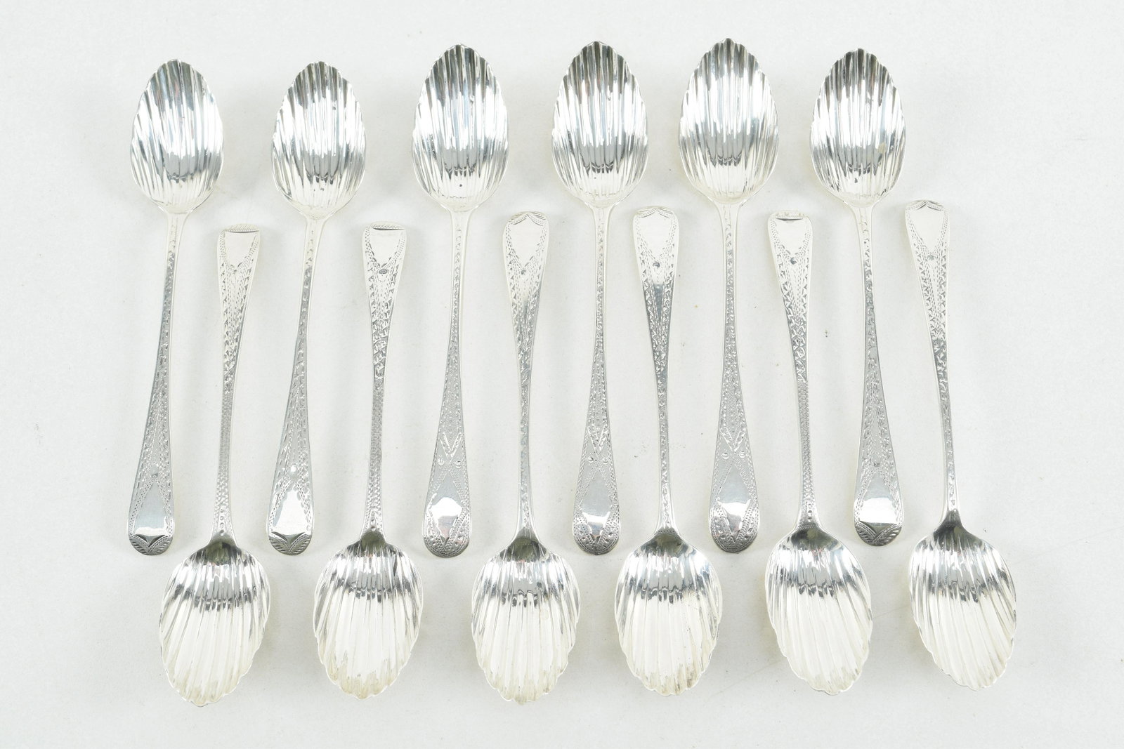 12 Georgian silver coffee or teaspoons, fluted bowl and: 12 Georgian silver coffee or teaspoons, fluted bowl and bright cut engraving, London, late 18th/early 19th century, John Beldon, Jos. Hardy, etc. 4.9 ozt. 5.5in length.