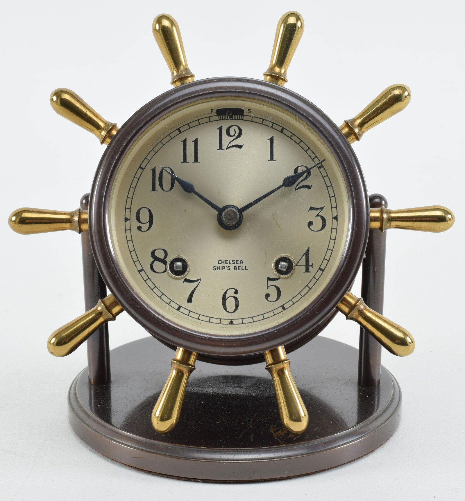 Chelsea Ships Bell Clock. Ship's wheel form. Appears to Barnebys