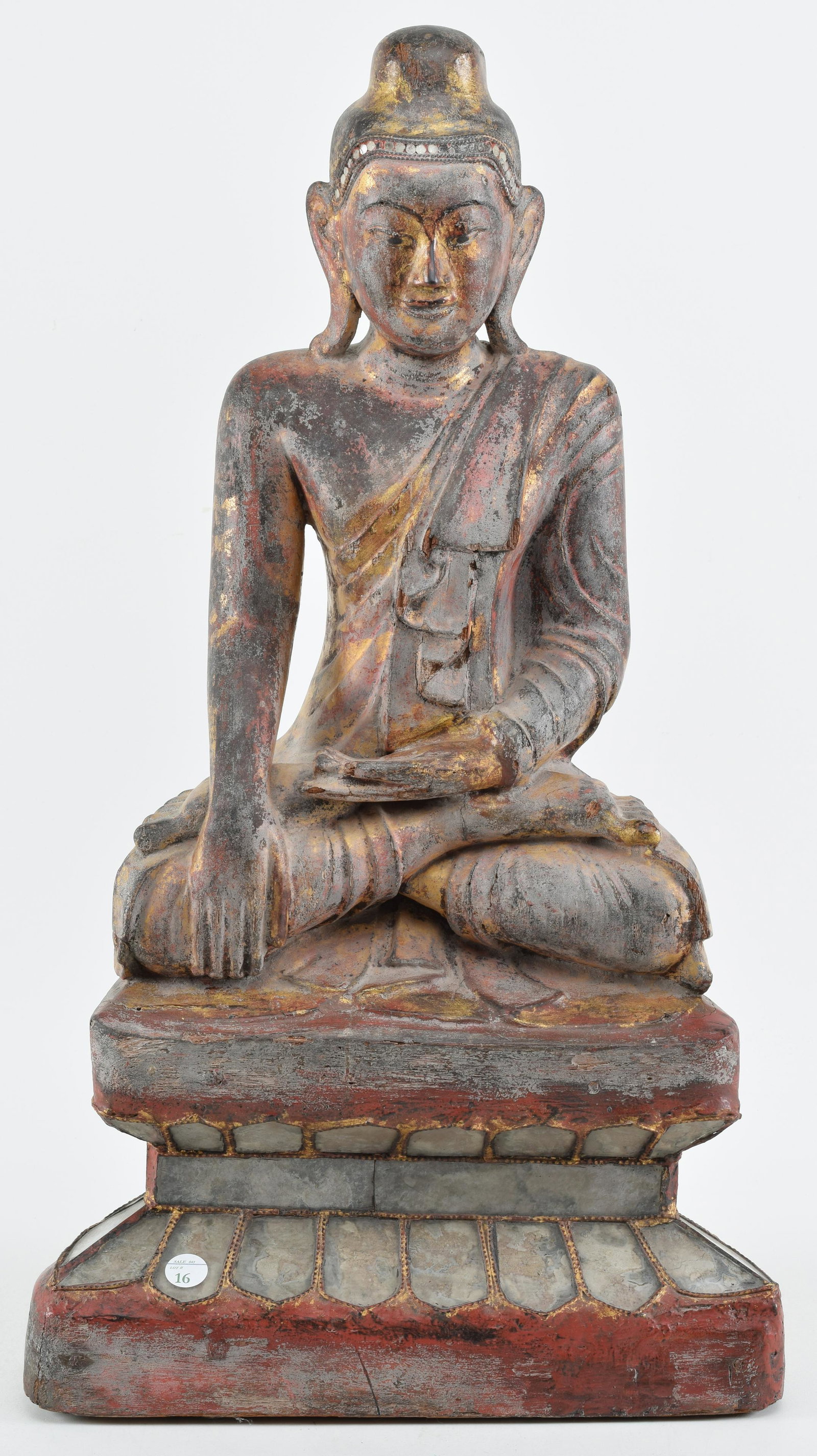 Burmese Buddha. Carved wood with red and gold: Burmese Buddha. Carved wood with red and gold decoration and inset glass panels. 24in high.