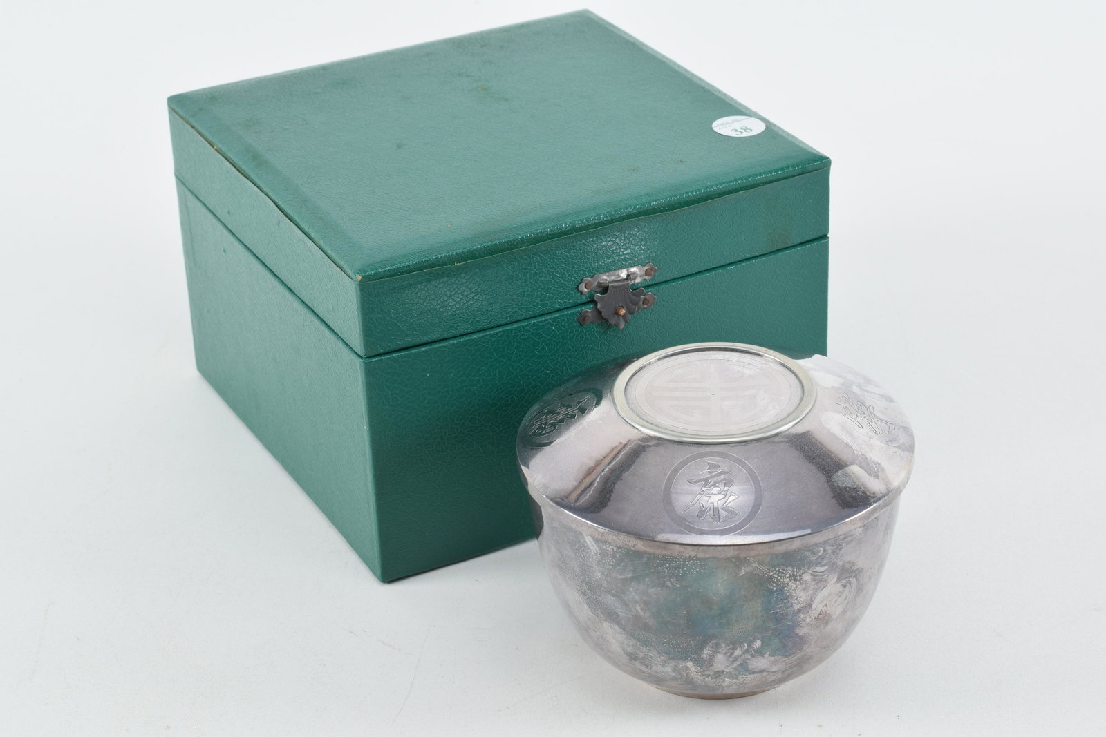 Korean lidded silver rice bowl with tooled character: Korean lidded silver rice bowl with tooled character cartouches. Family note stating the bowl is from Kil Soon Pak, 1962. Includes original box. 11.1 ozt. 5in diameter. Box measures 7.5 x 7.5 x 5in.