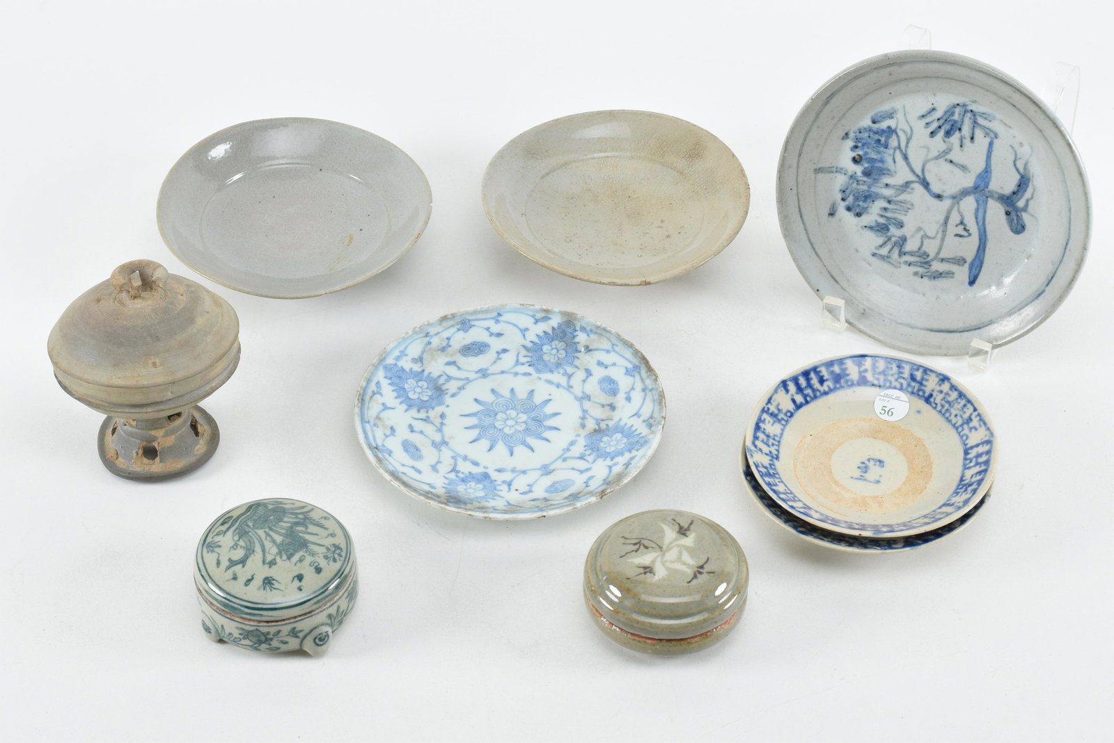 9 pieces of Chinese and Korean porcelains. To include:: 9 pieces of Chinese and Korean porcelains. To include: 6 saucers, 2 covered boxes, and a covered dish. Chips and wear. 7in diameter of largest.