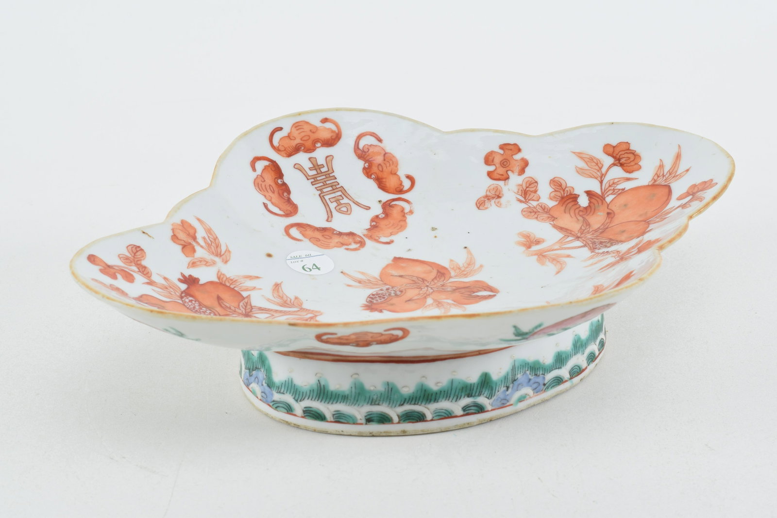 Chinese porcelain shaped footed dish. Iron red: Chinese porcelain shaped footed dish. Iron red decoration of peaches and bats. Seal on underside. 11in wide.