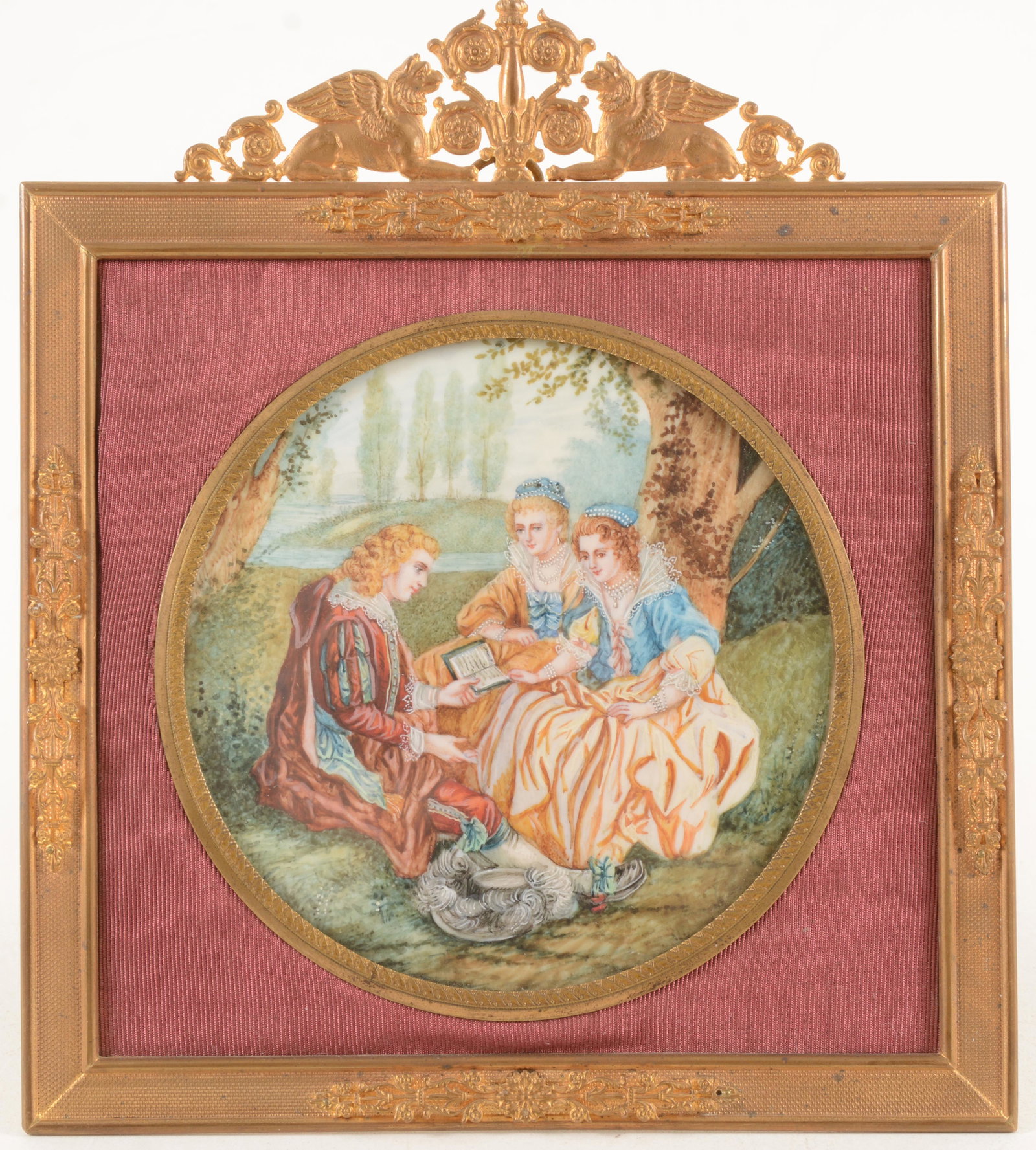 Miniature painting of Renaissance figures reading book: Miniature painting of Renaissance figures reading book in landscape. Round form with red fabric ground in frame. Metal frame with applied floral vignettes and scrollwork crest with Gryphons. 7.25 x 6.
