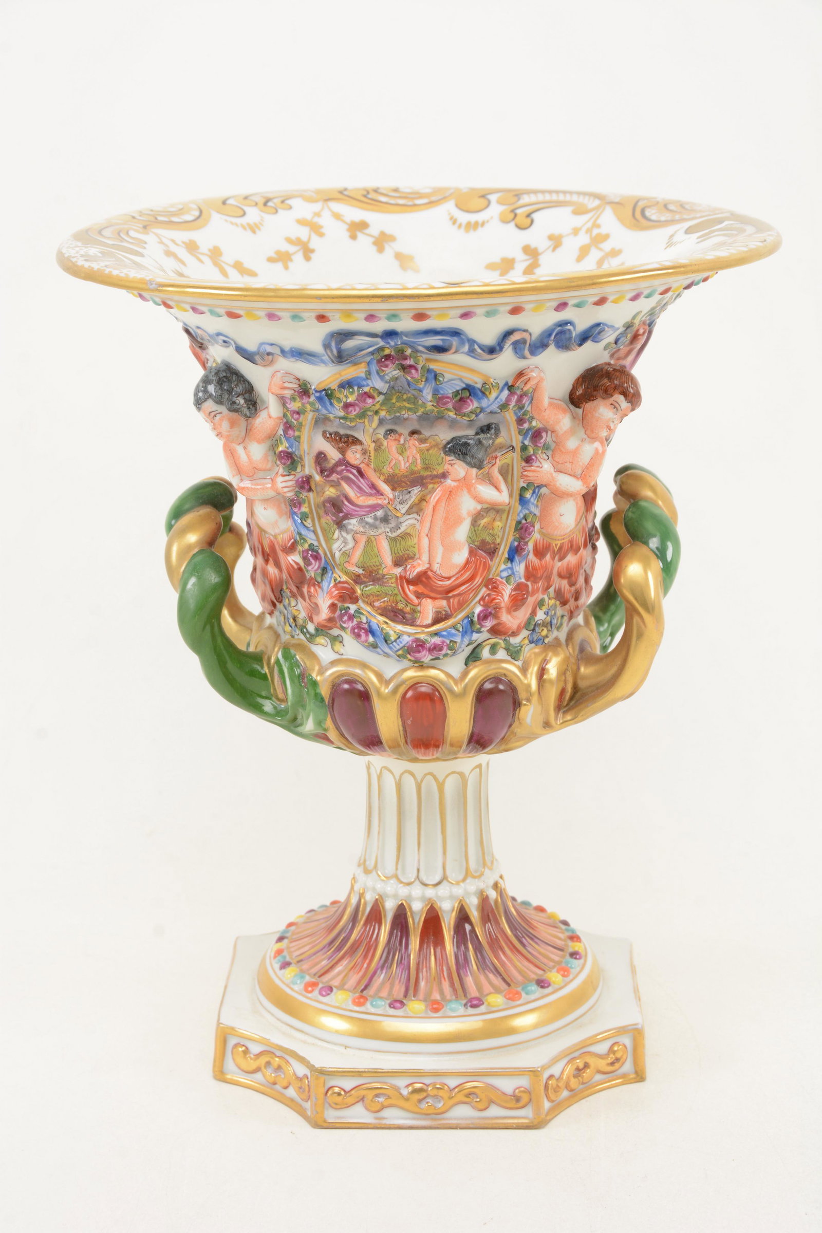 Early 20th century Capodimonte Campania form classical: Early 20th century Capodimonte Campania form classical vase with relief cherub. Floral garland decoration. Figural. Rope handles. Underglaze blue mark. Gilt decoration. 10.5in height.