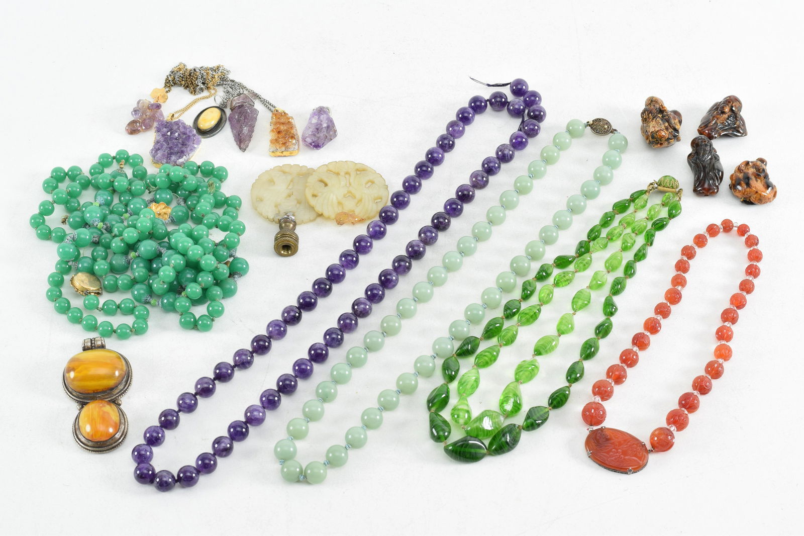 Assortment of stone bead jewelry and carvings. To (1 of 7)