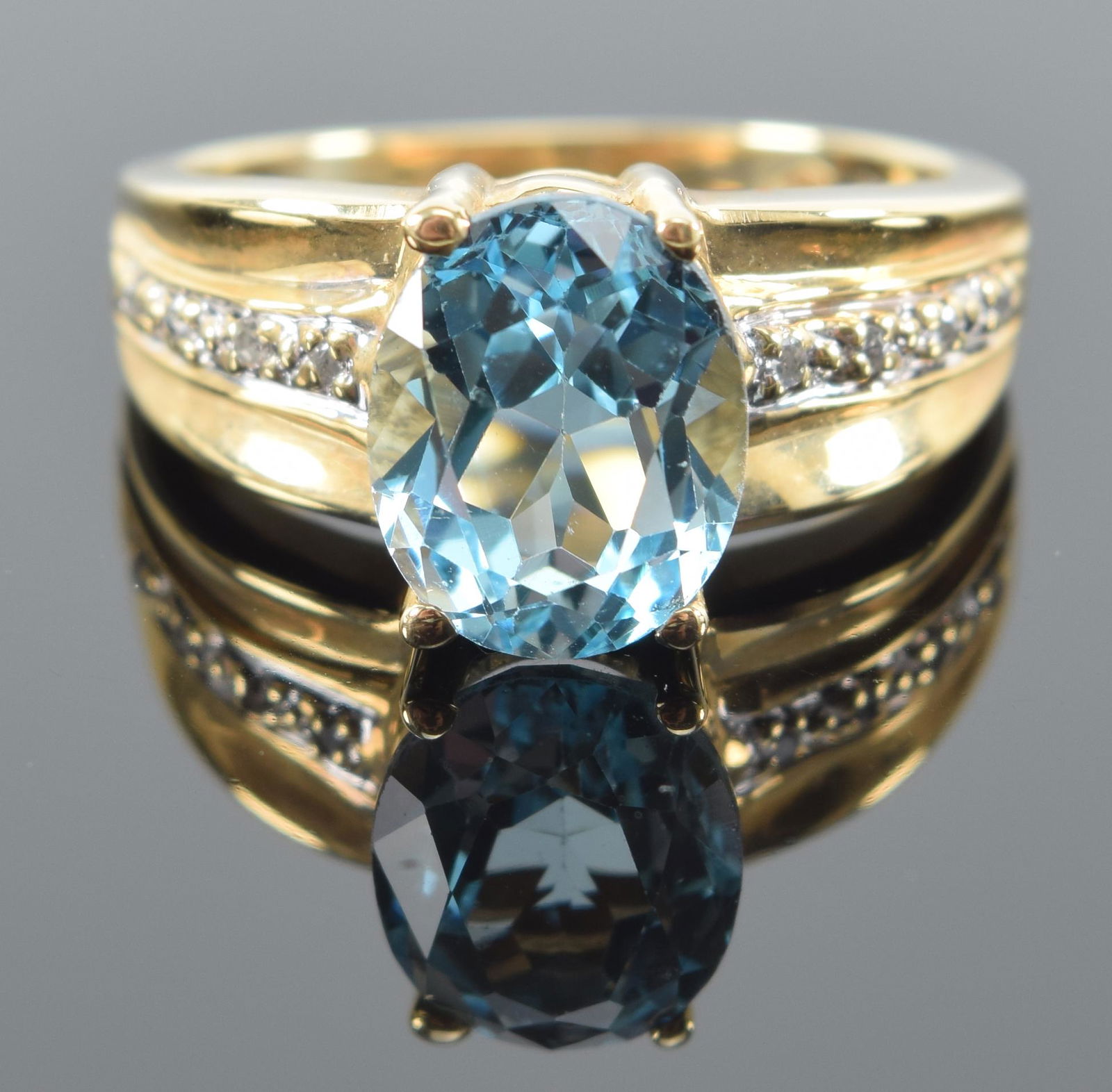 14K gold blue tourmaline and diamond mounted ring. Oval stone with diamond mounted sides. Marked 14 (1 of 7)