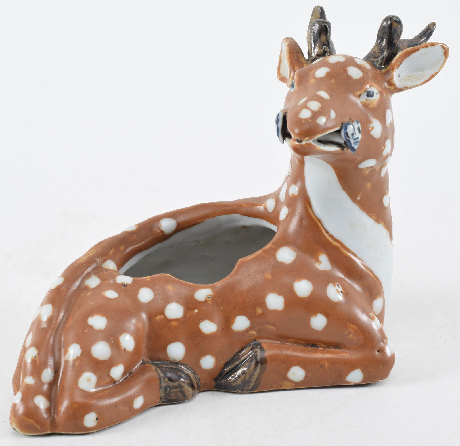 Porcelain vase. China. 19th century. Molded in the form of a reclining deer with a ling chih in its (1 of 8)