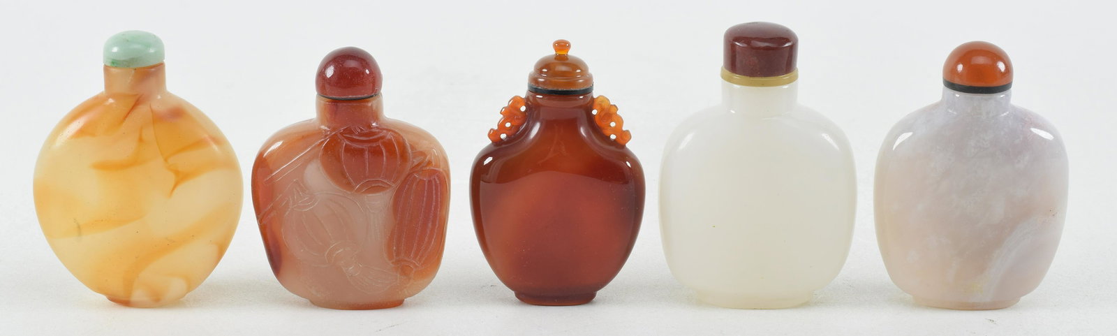 5 snuff bottles. China. Late 19th/early 20th century. To include: 1 jade, 2 carnelian, and 2 peking: 5 snuff bottles. China. Late 19th/early 20th century. To include: 1 jade, 2 carnelian, and 2 peking glass. Largest: 3in.