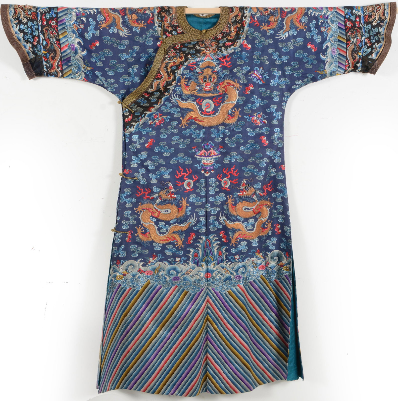 Dragon robe. China. Late 19th century. Dark blue ground. Embroidery of dragons in gold and: Dragon robe. China. Late 19th century. Dark blue ground. Embroidery of dragons in gold and auspicious emblems.