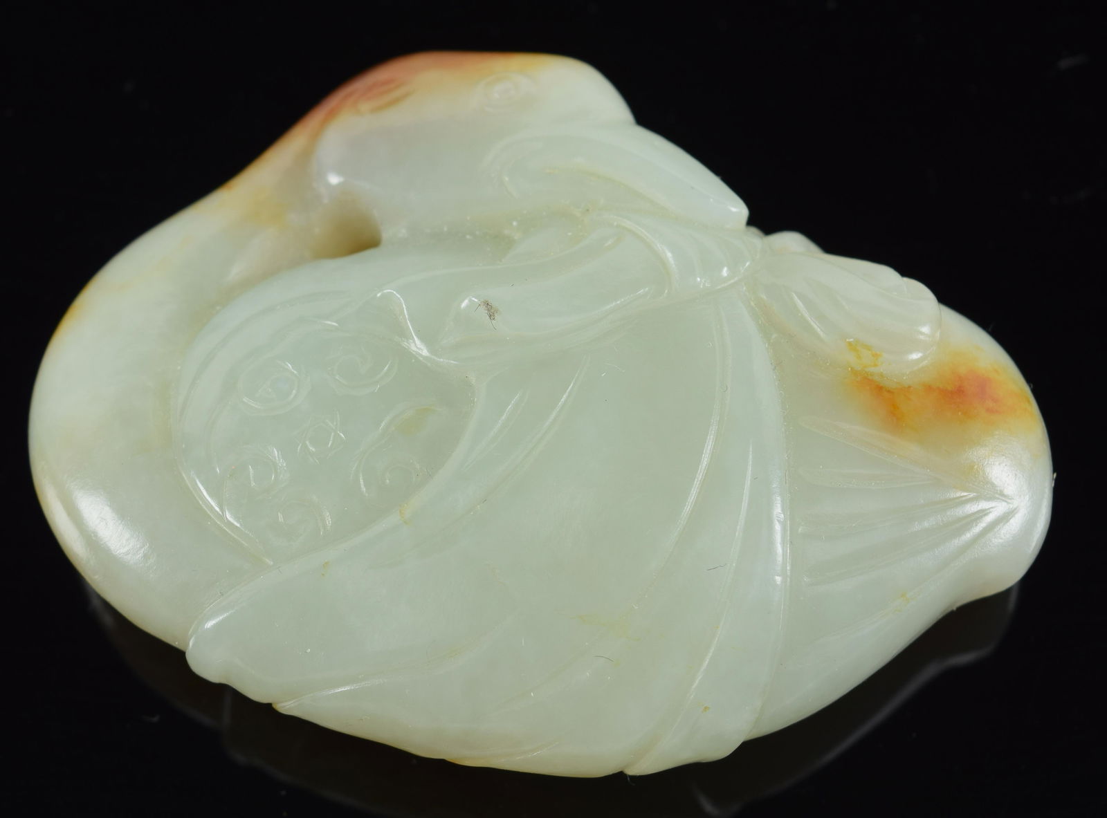 Jade carving. China. 18th century or earlier. Stone of a litchee white color with russet markings. (1 of 4)