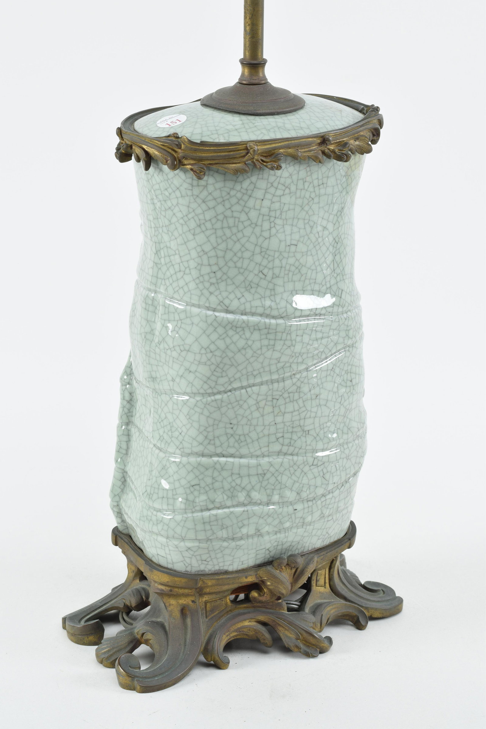 Porcelain vase. China. Early 20th century. Bamboo section with a crackled celadon glaze. French: Porcelain vase. China. Early 20th century. Bamboo section with a crackled celadon glaze. French rococo brass mounts. Drilled for a lamp. Area of repair at the mouth. Base mount with repair. 11in high 
