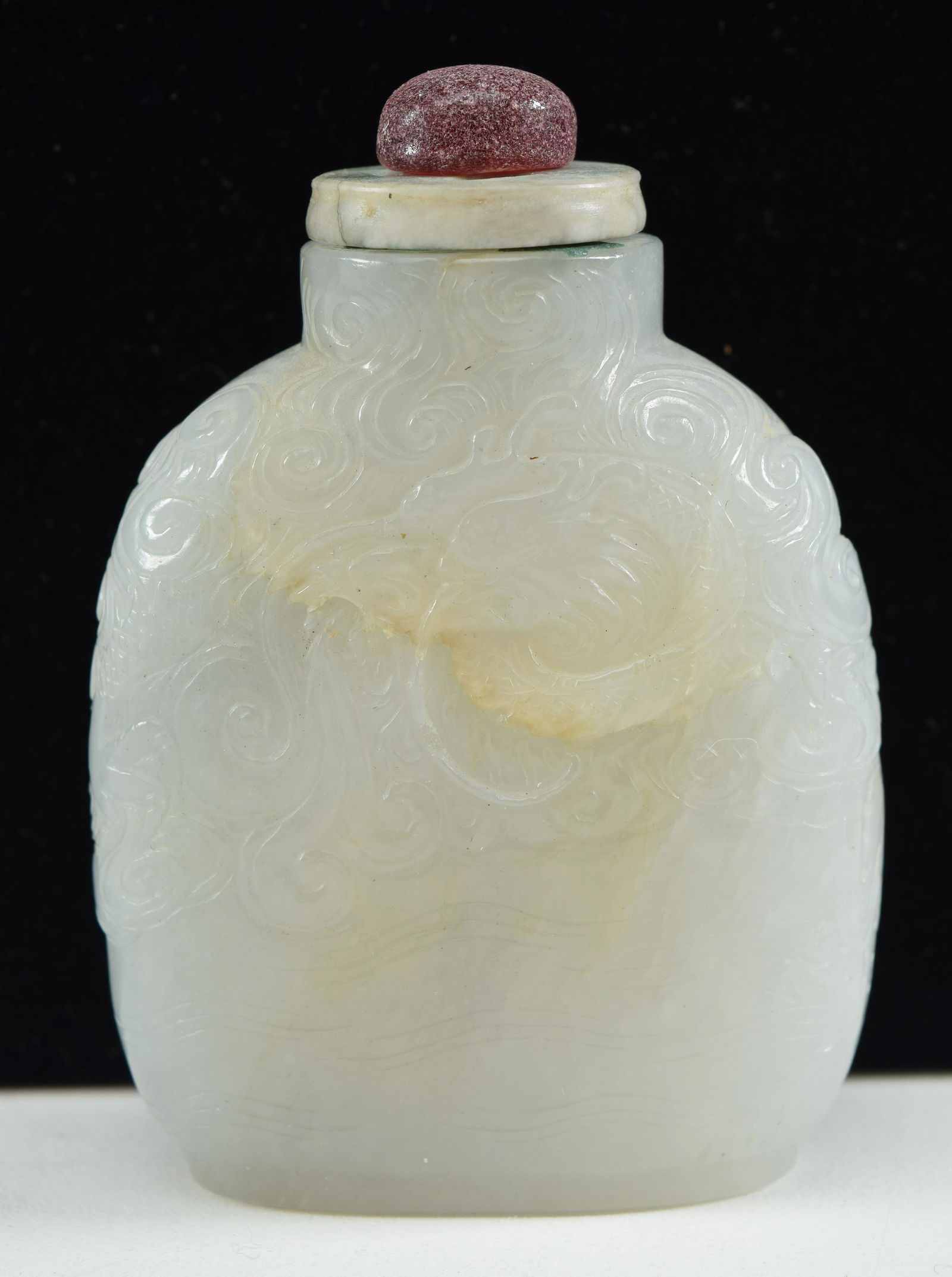 Jade snuff bottle. China. 18th century. Pure white color. surface carved with dragons and clouds. (1 of 9)
