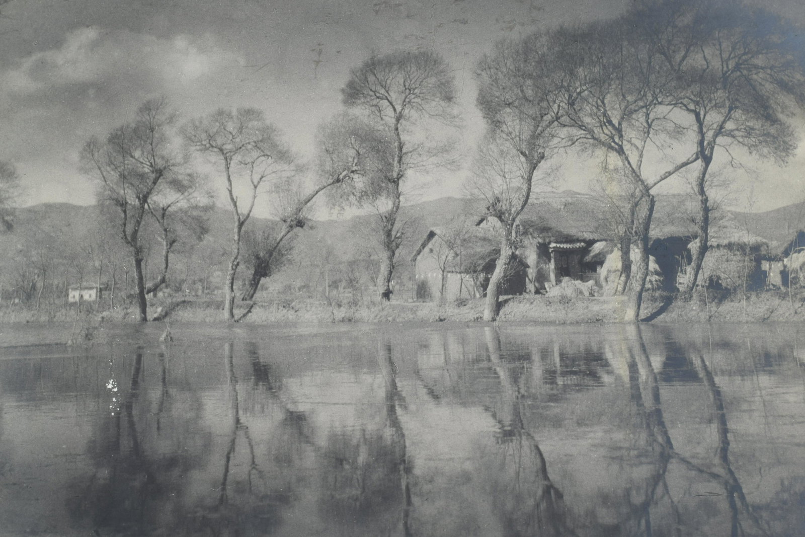Chin San Long. China. Original landscape photograph depicting a house and out buildings near a lake: Chin San Long. China. Original landscape photograph depicting a house and out buildings near a lake with trees. Mid-20th century. Unsigned. With attached note by Earl Wilson stating provenance and att