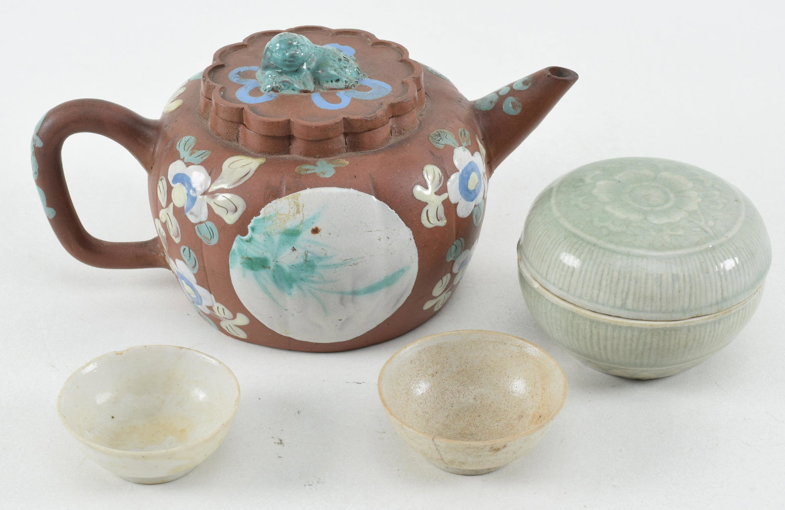 Lot of 3 porcelains. China. 19th century. To include: a Yi Hsing teapot, a celadon incense box, and: Lot of 3 porcelains. China. 19th century. To include: a Yi Hsing teapot, a celadon incense box, and a small vase.