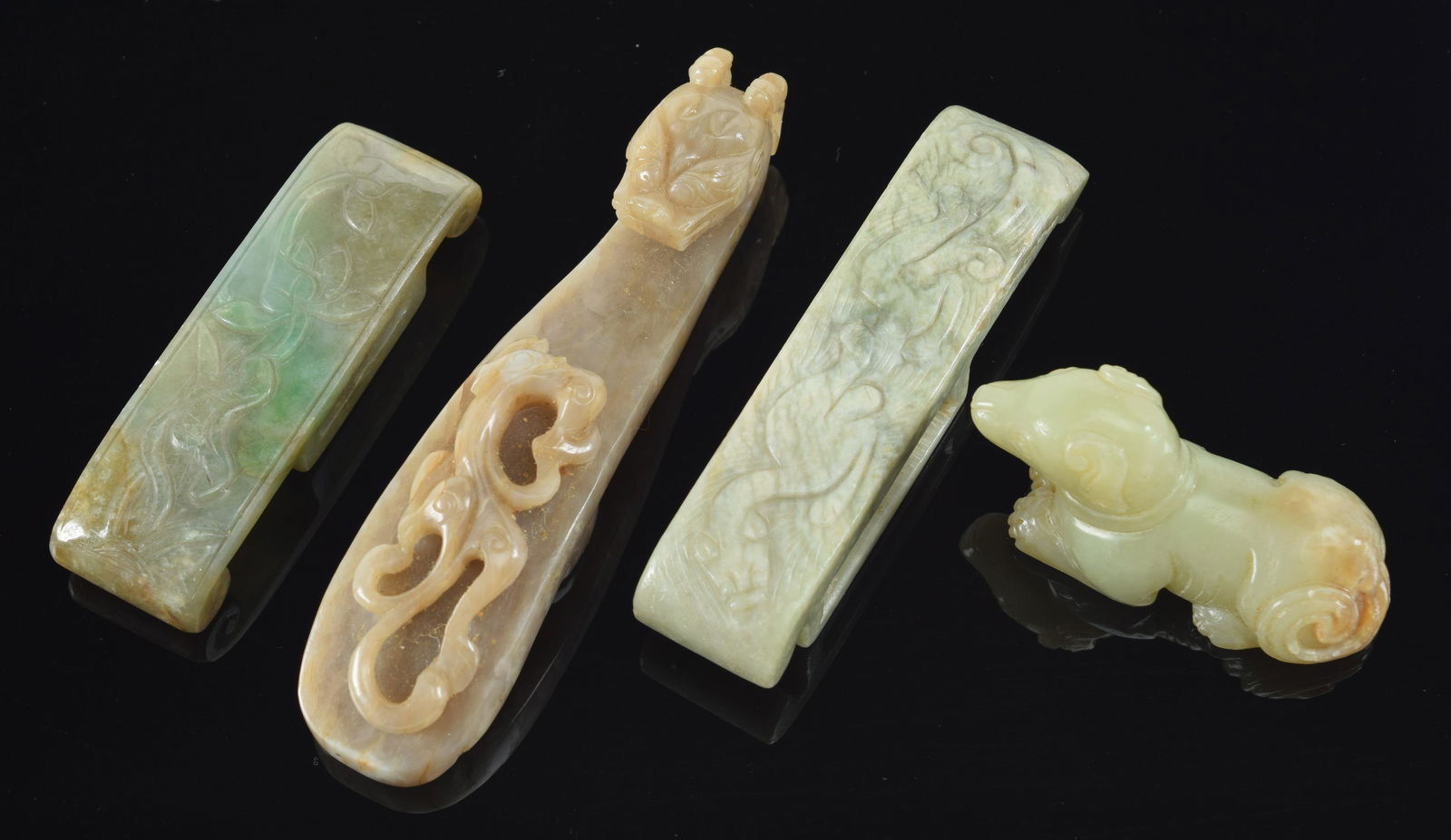 Lot of 4 jades. China. 19th century. To include: 3 belt slides and a dog. Largest 4.5in length. (1 of 6)