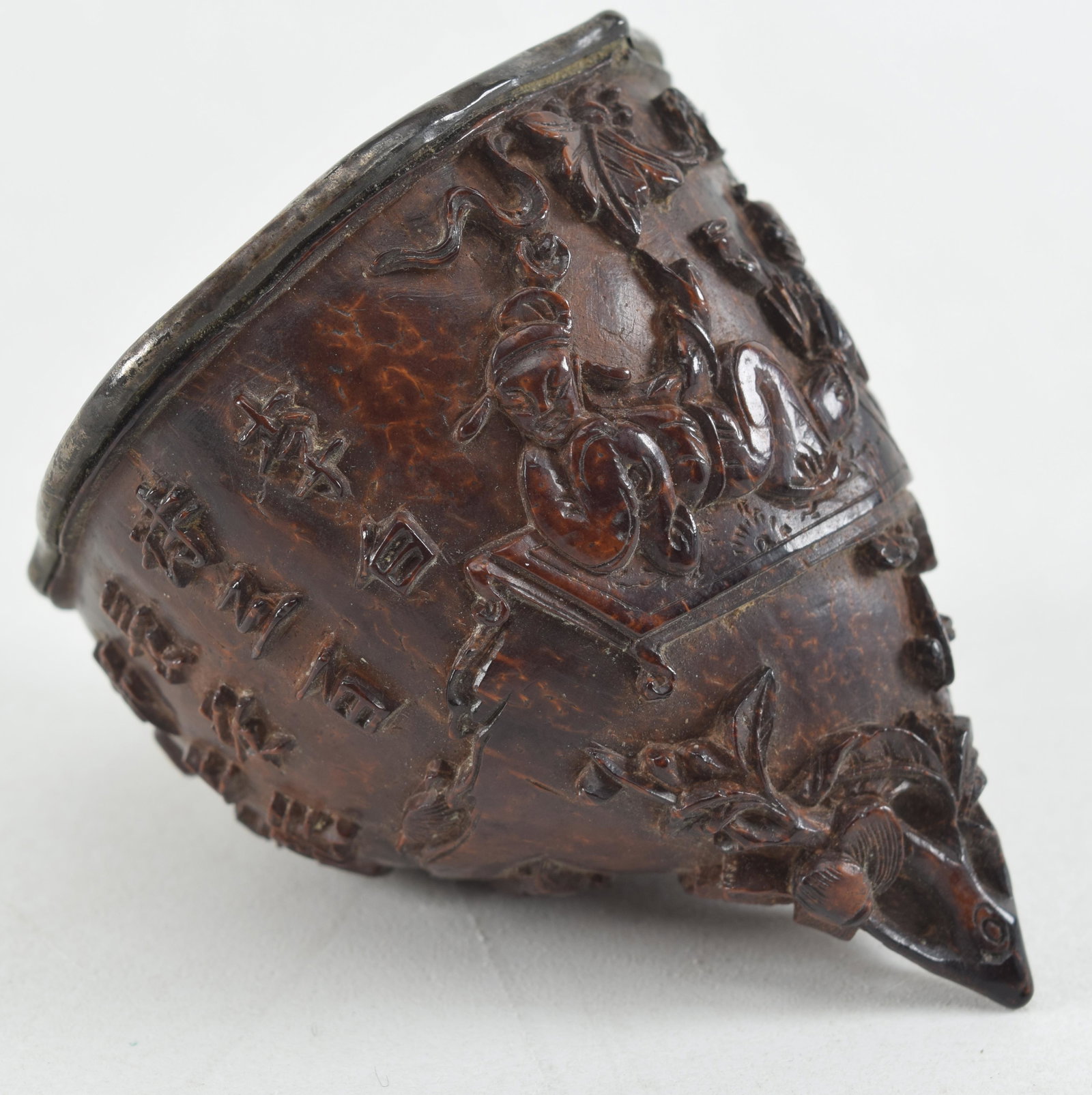 Fine carved coconut shell cup. China. 18th century. Ornately carved scene of the Red Cliffs with a: Fine carved coconut shell cup. China. 18th century. Ornately carved scene of the Red Cliffs with a poem. Silver liner. 2.75in length.