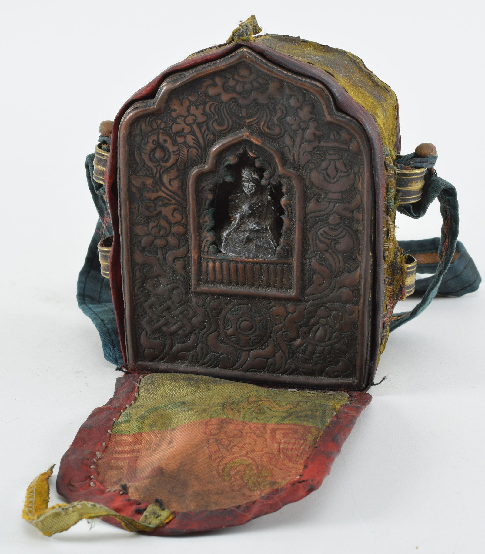 Portable shrine. Tibet. Early 20th century. Repousse copper. Brocade mounts. (1 of 6)