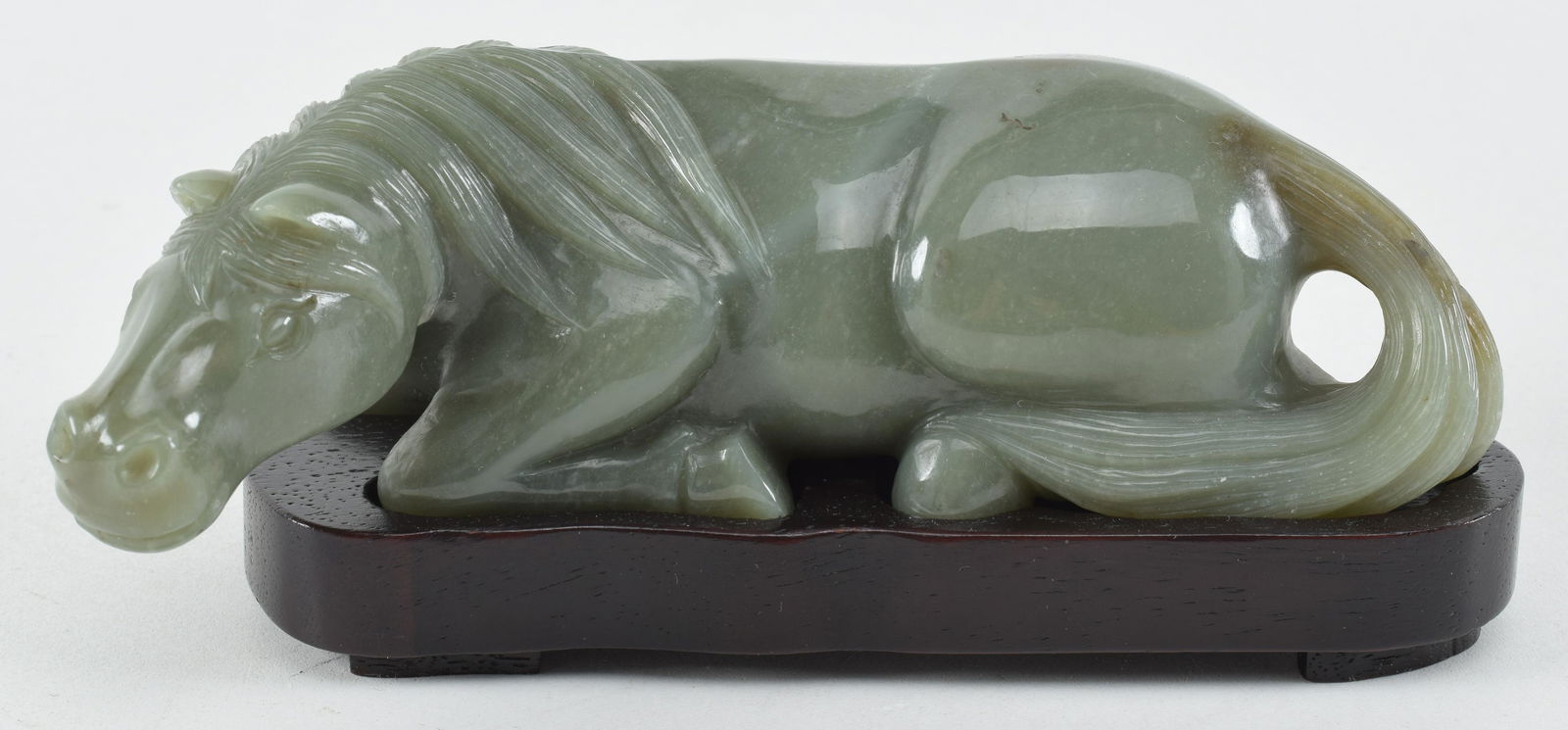 Jade carving. China. 20th century. Grey green stone. Study of a reclining horse. 7in length. (1 of 5)