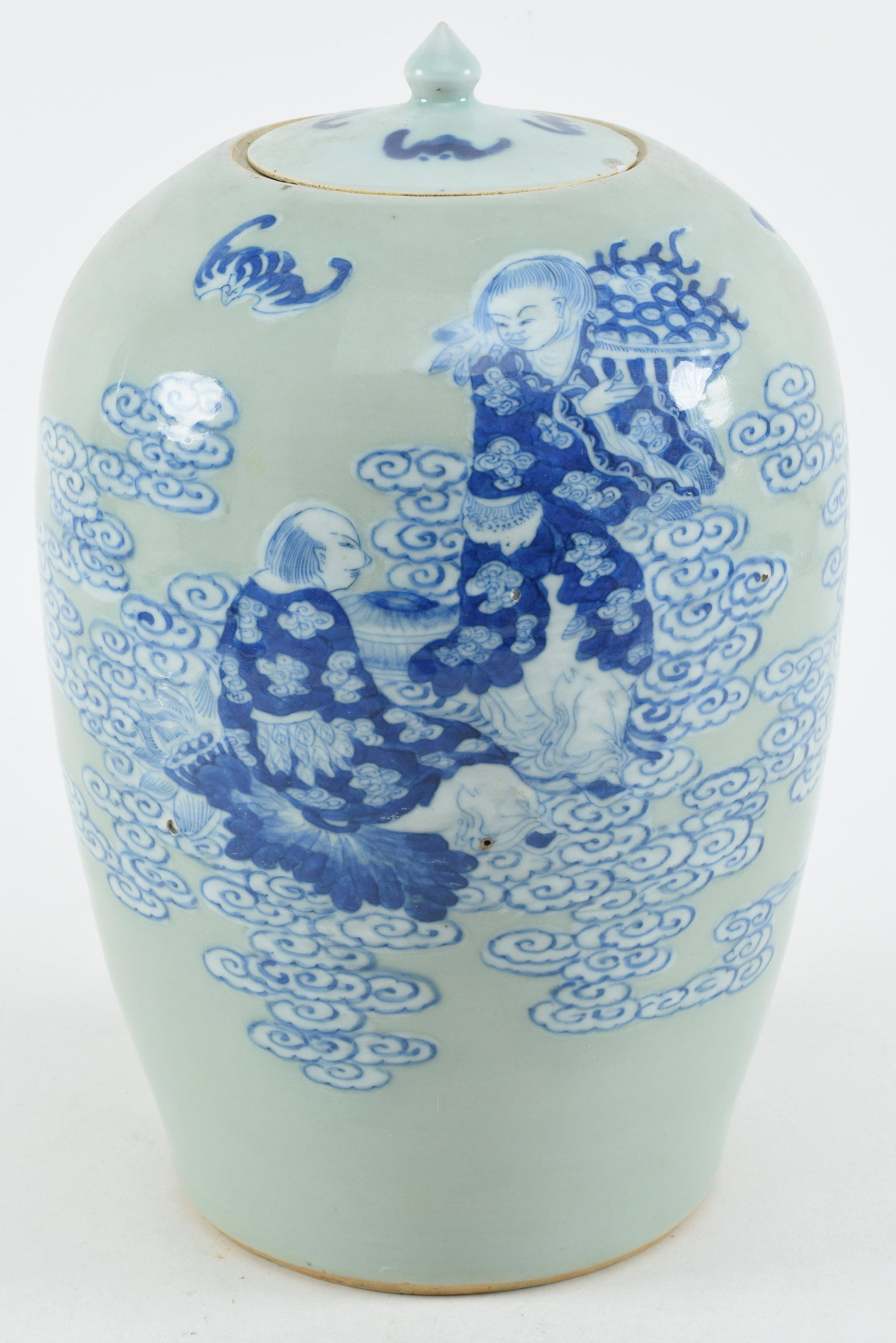 Porcelain covered jar. China. Late 19th century. Ovoid form shape. Celadon ground with underglaze: Porcelain covered jar. China. Late 19th century. Ovoid form shape. Celadon ground with underglaze blue decoration of the ho ho erh hsien twins. 12in height.