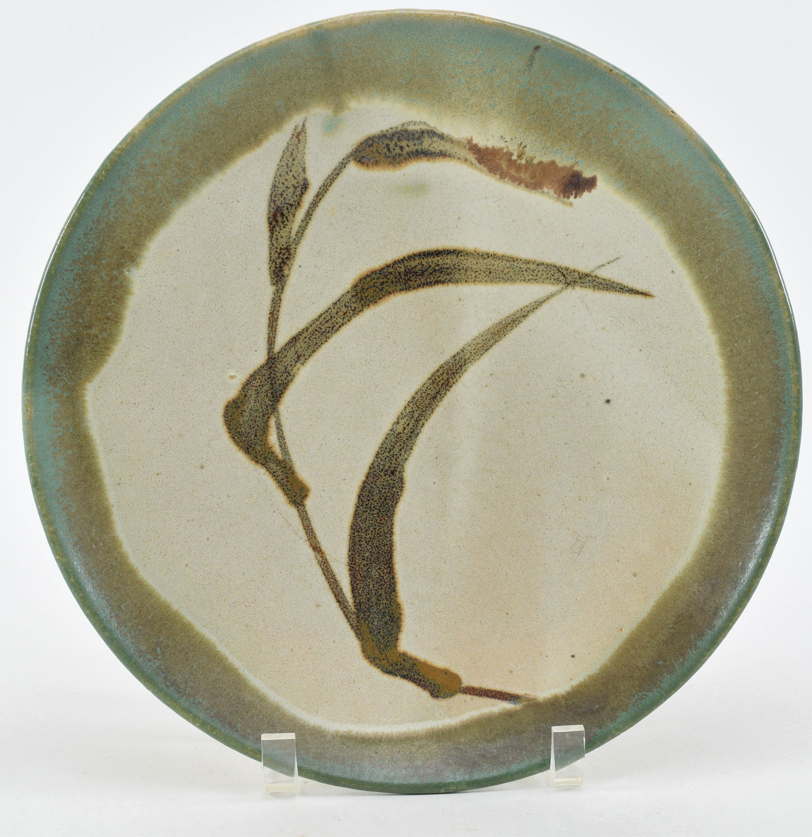 Stoneware plate. Japan. Mid-20th century. Mashiko ware. Attributed to Shoji Hamada. Sprig of autumn: Stoneware plate. Japan. Mid-20th century. Mashiko ware. Attributed to Shoji Hamada. Sprig of autumn grasses. 11in.