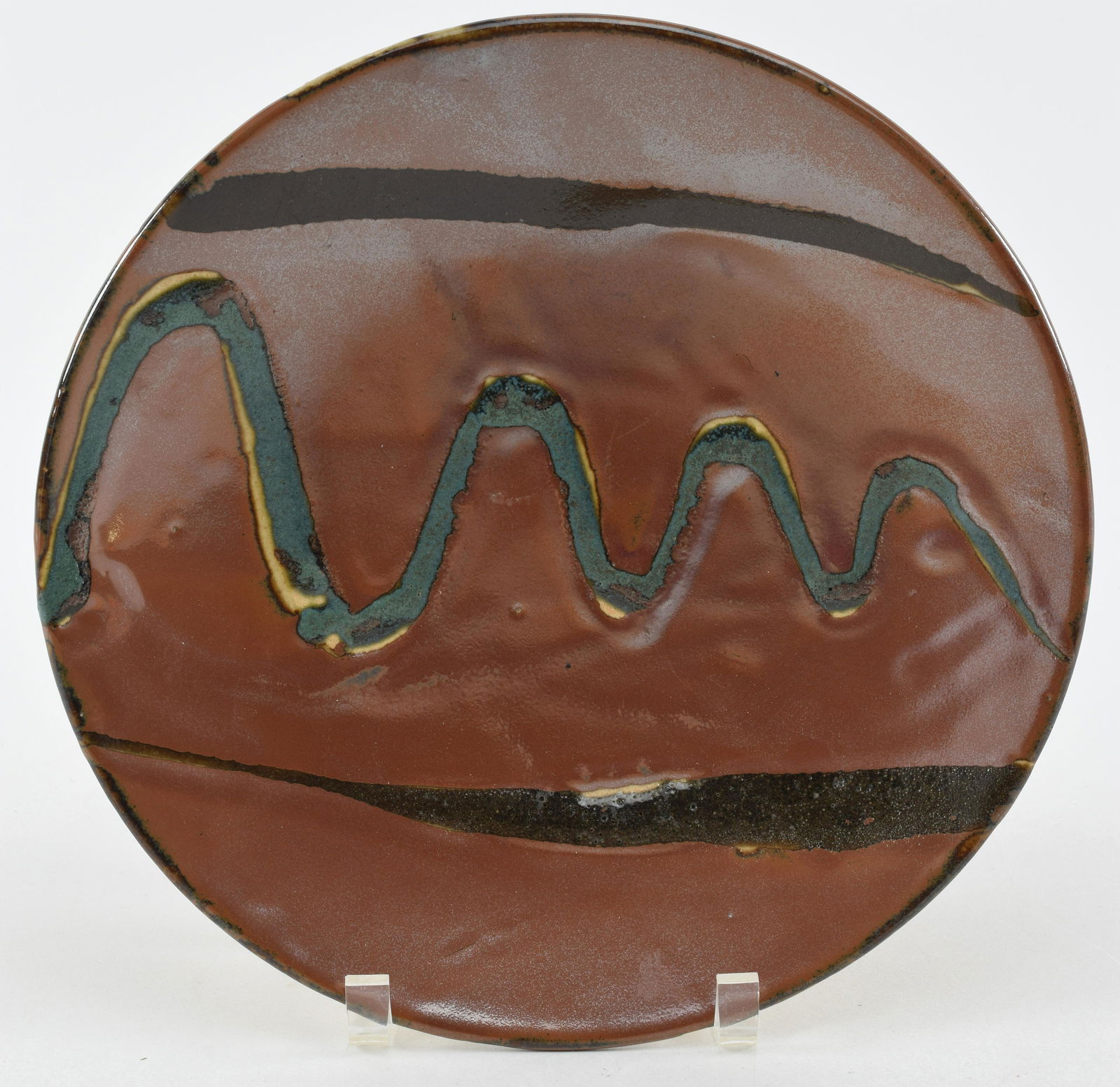 Stoneware plate. Japan. Mid-20th century. Mashiko ware. Attributed to Shoji Hamada. Persimmon glaze: Stoneware plate. Japan. Mid-20th century. Mashiko ware. Attributed to Shoji Hamada. Persimmon glaze and streaks 11.5in.