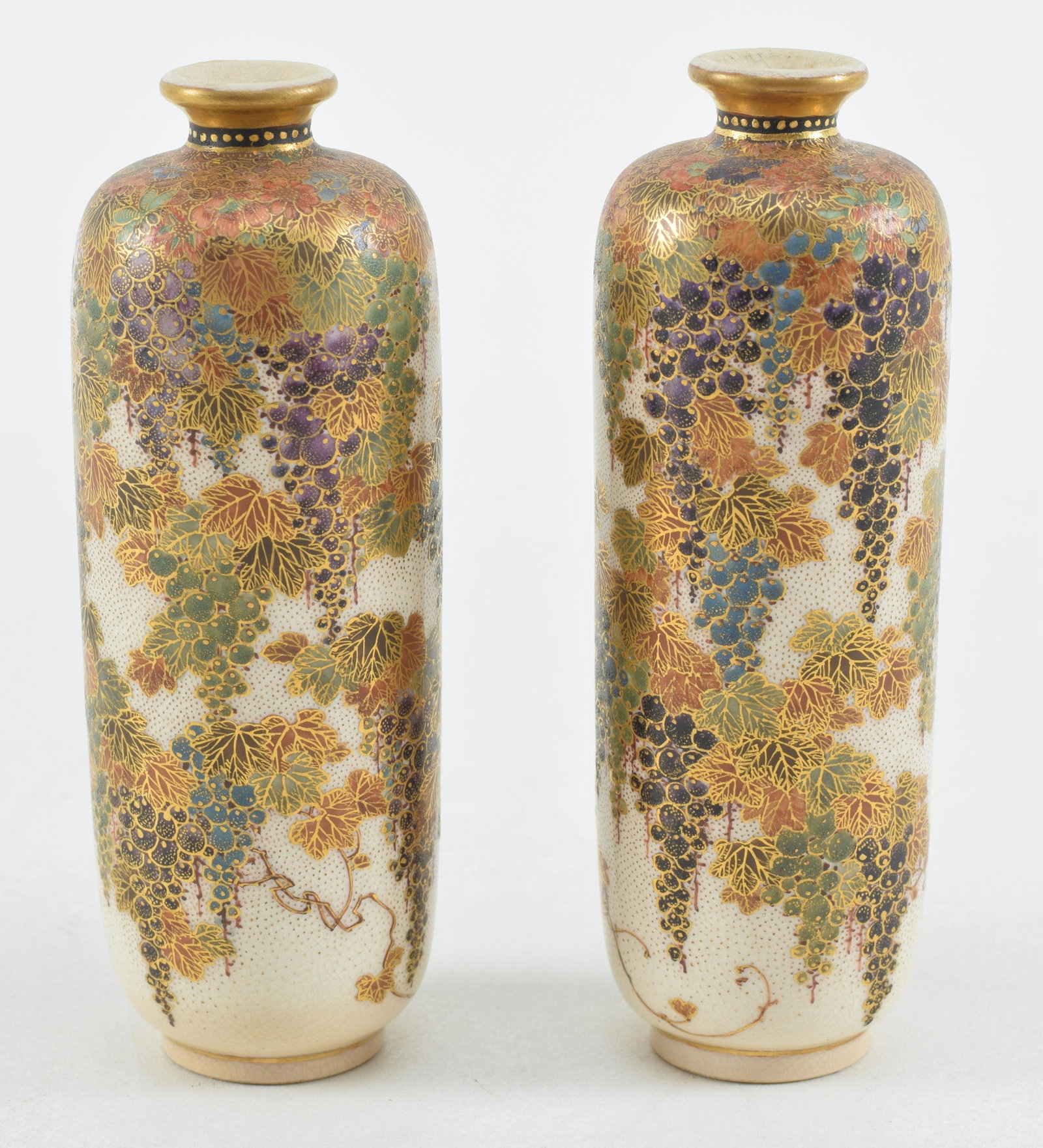 Pair of satsuma vases. Japan. Meiji period (1868-1912). Cylindrical form. Decoration of grape vines: Pair of satsuma vases. Japan. Meiji period (1868-1912). Cylindrical form. Decoration of grape vines and flowers. Signed Meizan. 5in high.
