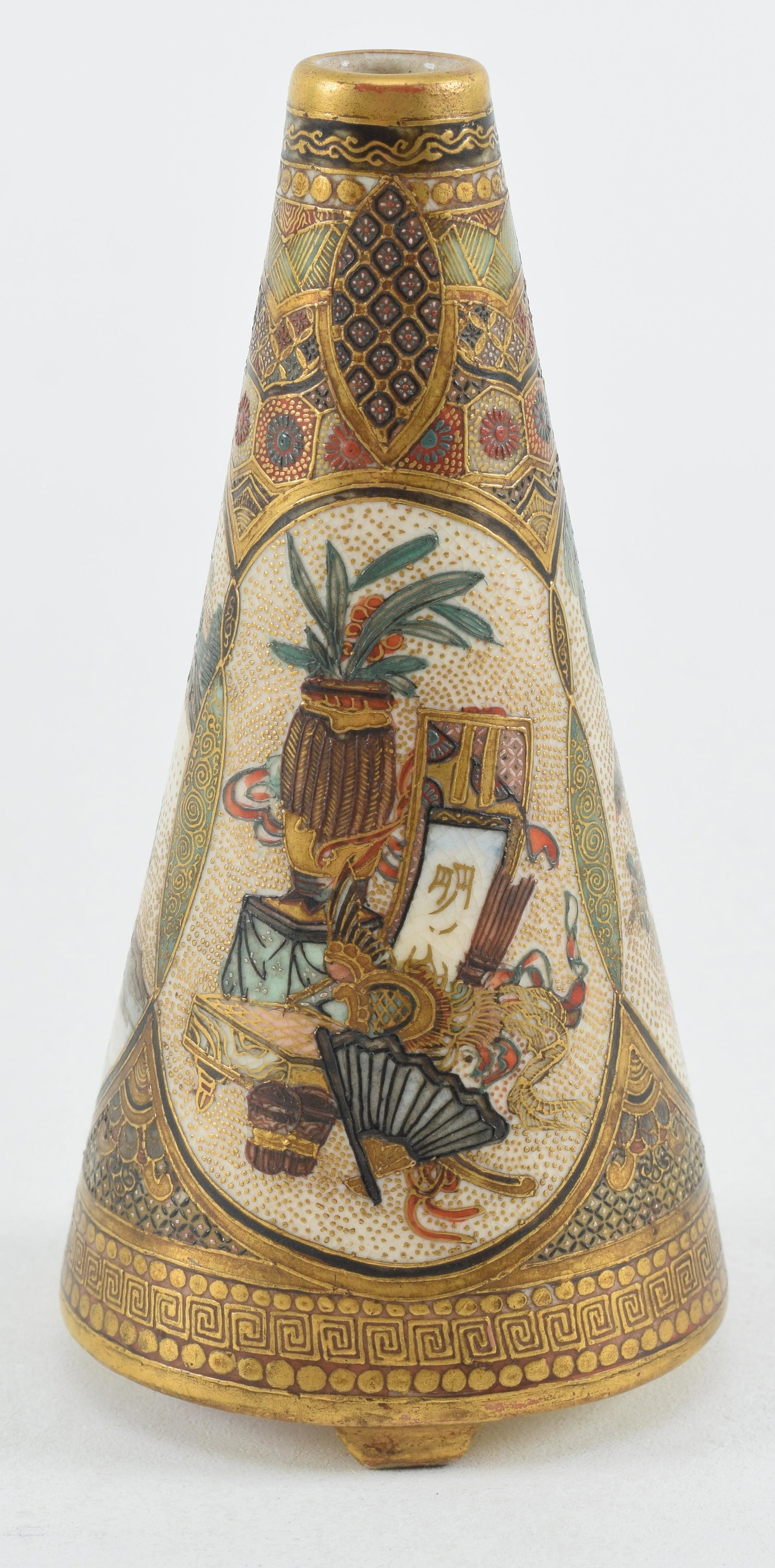 Satsuma vase. Japan. Meiji period (1868-1912). Conical shape with tripod feet. Decoration of the: Satsuma vase. Japan. Meiji period (1868-1912). Conical shape with tripod feet. Decoration of the hundred antiques, birds and flowers and brocade patterns. Signed Meizan on a scroll and the base. 4in h