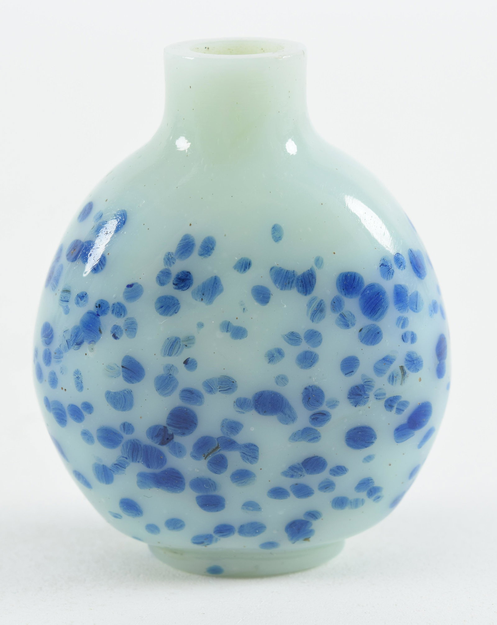 Peking glass snuff bottle. China. 19th century. White with blue spots. 2.5in.: Peking glass snuff bottle. China. 19th century. White with blue spots. 2.5in.