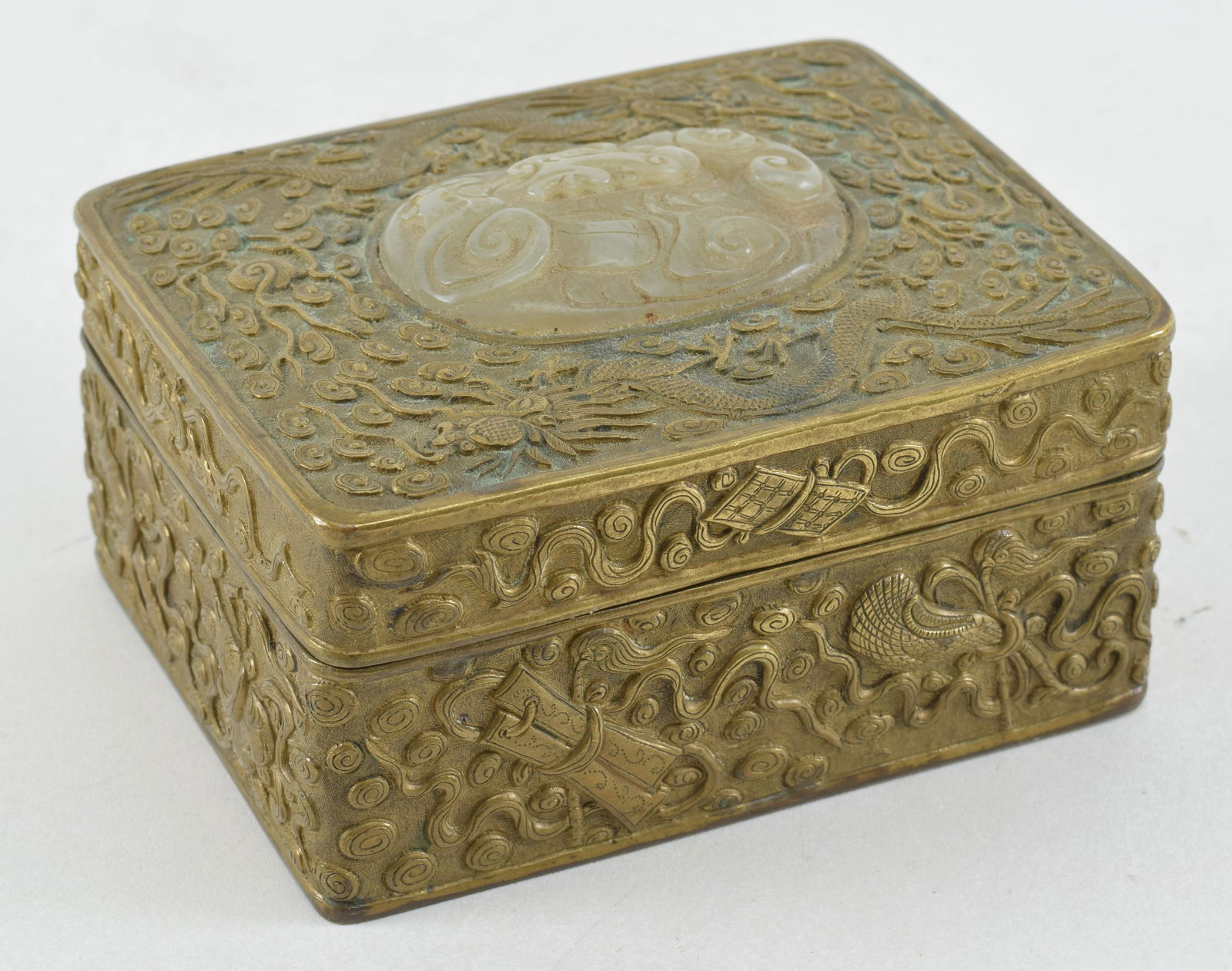 Repousse brass box set with a jade carving. China. 19th century. Surface with dragons and clouds. (1 of 7)