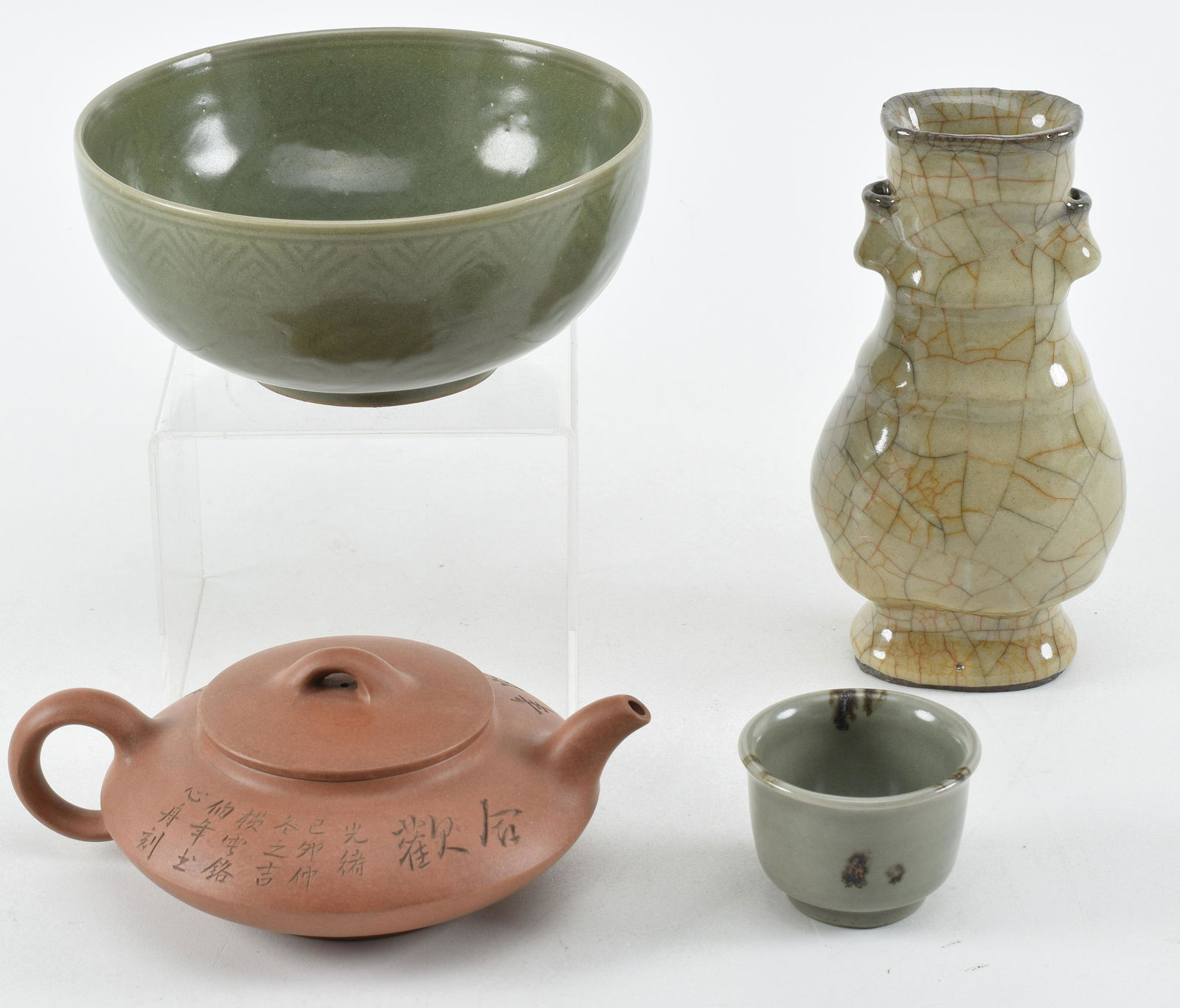 Lot of 4 ceramics. China. 20th century. To include: a kuan style vase, a celadon bowl, a buckwheat: Lot of 4 ceramics. China. 20th century. To include: a kuan style vase, a celadon bowl, a buckwheat celadon cup, and a Yi Hsing tea pot. Largest 6.75in.
