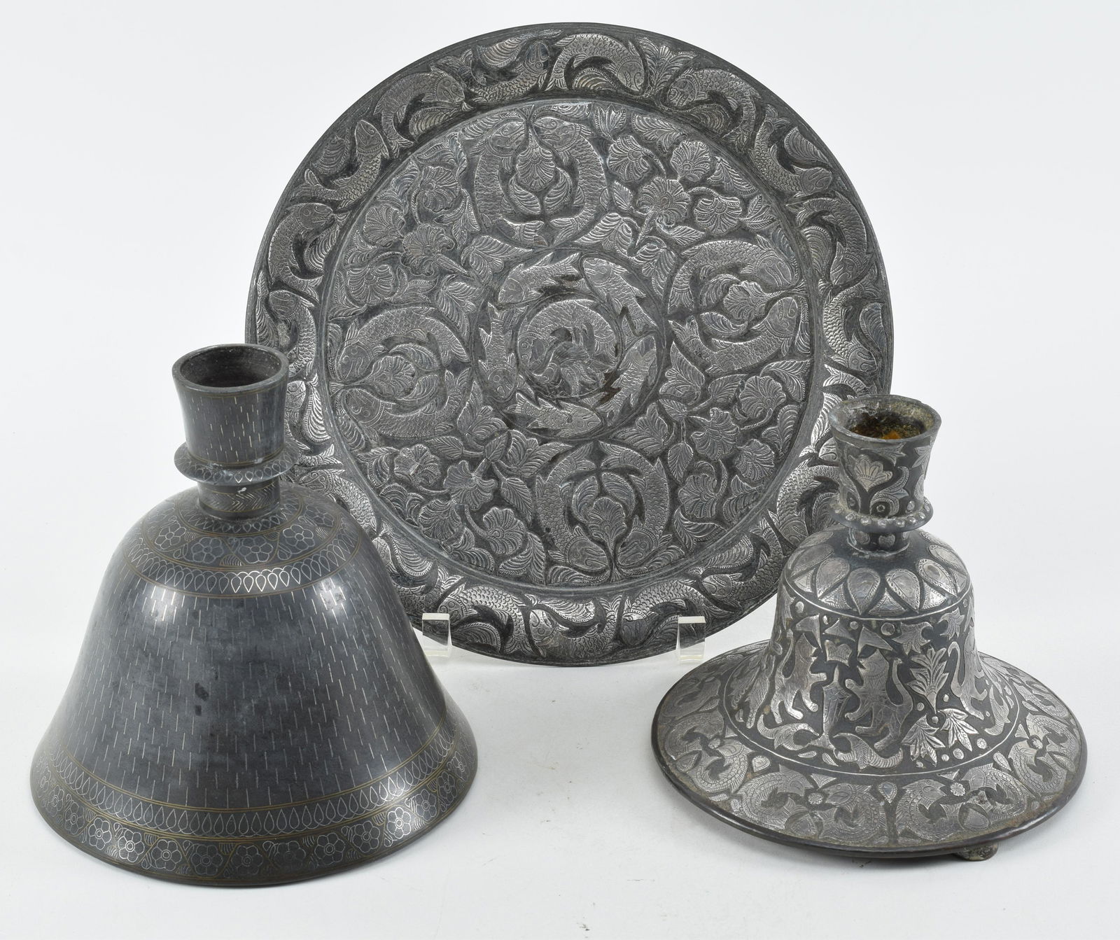 Lot of 3 metal works. India. 19th century. Bidri work. Decoration of fish and flowers and geometric: Lot of 3 metal works. India. 19th century. Bidri work. Decoration of fish and flowers and geometric patterns. To include 2 hukkah vases and a plate. Largest 8in high.
