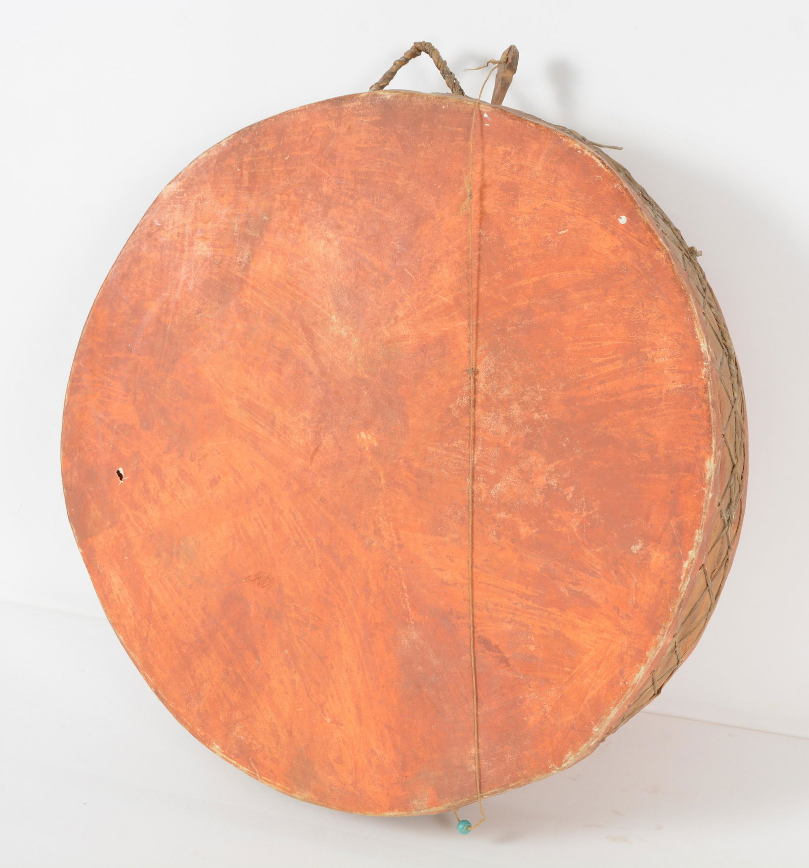 Native American Double Headed Frame Drum with Pink-Orange Paint and one Turquoise Bead on a string.: Native American Double Headed Frame Drum with Pink-Orange Paint and one Turquoise Bead on a string. Likely late 19th century ceremonial. Measures 24" diameter x 4-1/4" wide. Similar styles have been n
