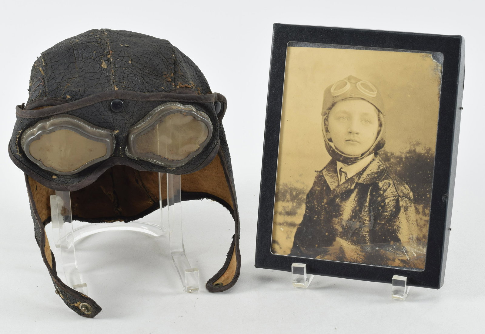 Early Flight Cap, Goggles, and Pilot Photograph Lot of items. The WWI era skull cap and goggles do: Early Flight Cap, Goggles, and Pilot Photograph Lot of items. The WWI era skull cap and goggles do not have observed makers marks and both are complete. Some scattered leather leather loss on both ite