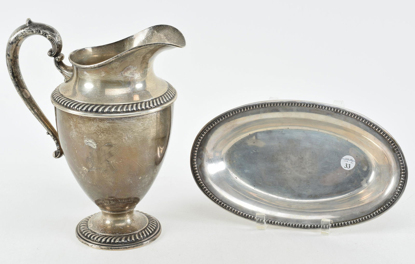 Sterling silver water pitcher and bread tray. 1) Water pitcher with gadrooned borders and spurred (1 of 11)