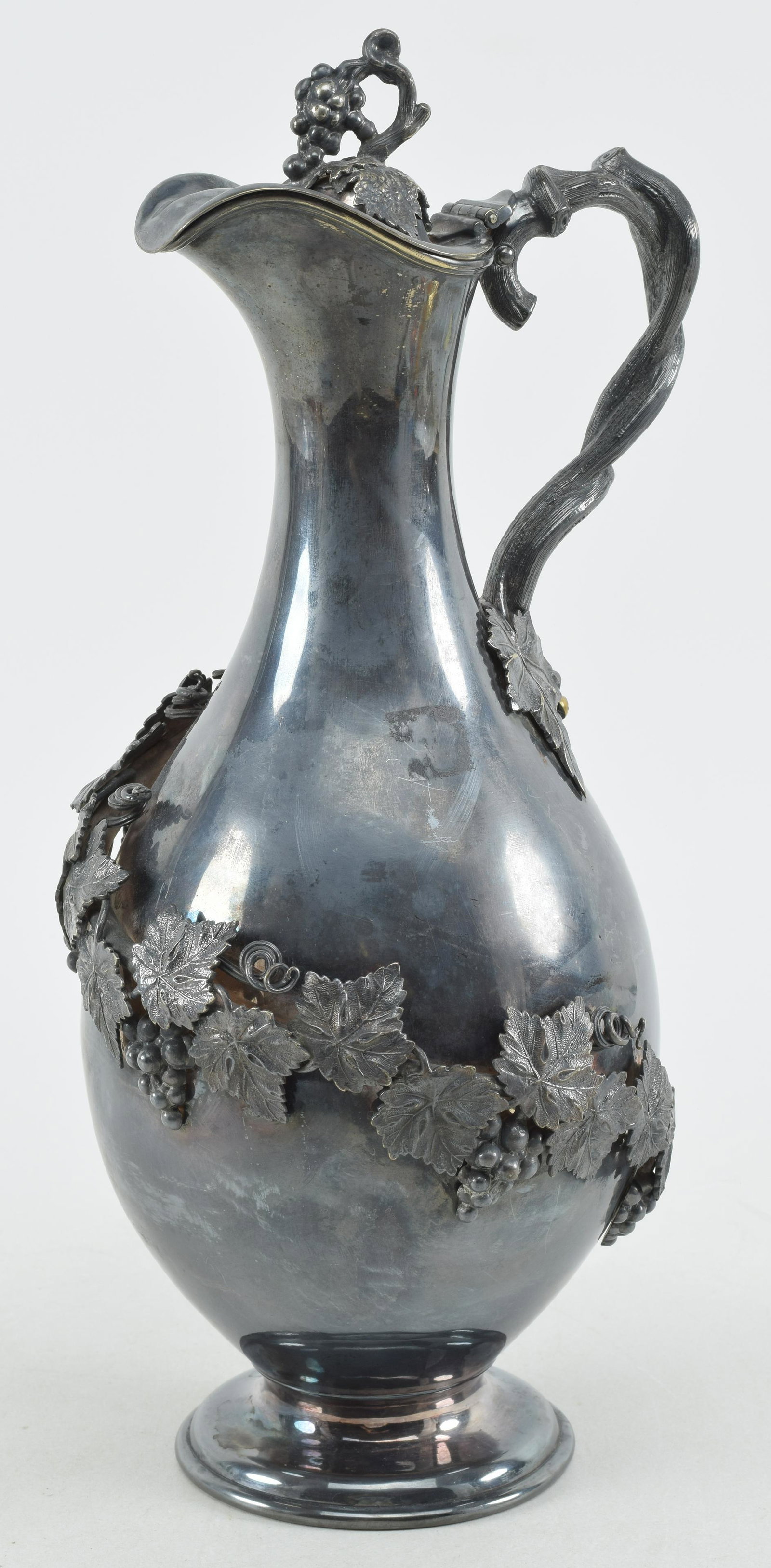 Antique Walker and Hall silver plated wine ewer with applied twisting vine and grape cluster: Antique Walker and Hall silver plated wine ewer with applied twisting vine and grape cluster decoration. Grape and leaf finial. Twisted vine branch handle. Marked on underside. 13.25in high.