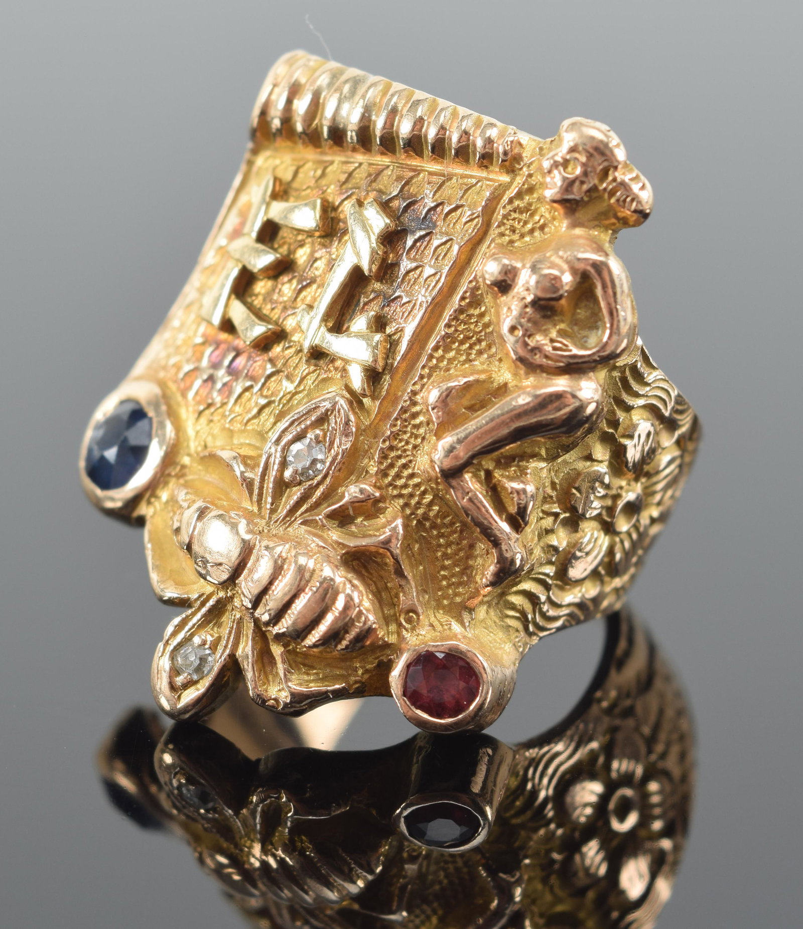 14K heavy gold figural sculpted ring. Nude woman, bee, and E.L. monogram. Colored stone mounts. Tiny: 14K heavy gold figural sculpted ring. Nude woman, bee, and E.L. monogram. Colored stone mounts. Tiny diamonds in bee wings. 8/8.25 ring size. 1in long. 16.8 grams. Flea bite in sapphire.