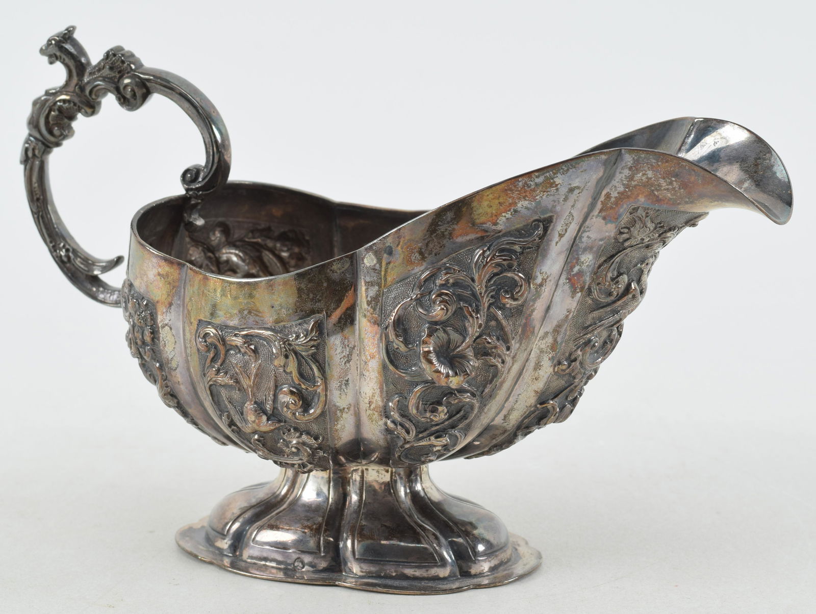 Continental silver sauce boat with repousse decoration of birds, flowers, and filigree background. (1 of 9)