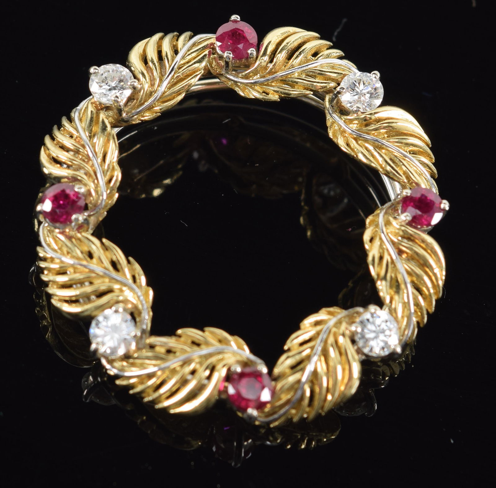 18K gold wreath form pin-pendant mounted with diamonds and rubies. Marked 18K and KORAL. Diamonds (1 of 4)