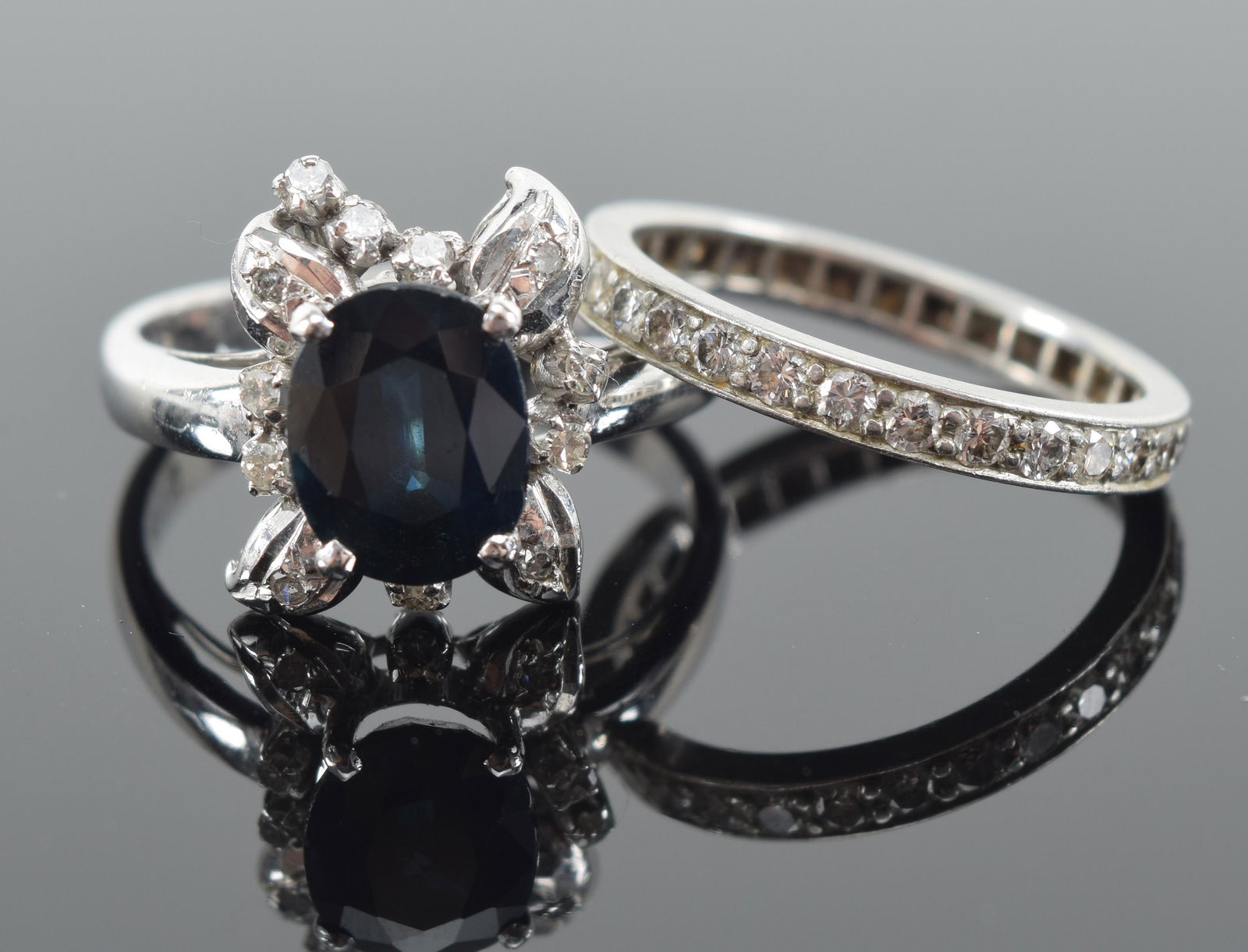 2 gold rings. 1) 18K white gold diamond and sapphire mounted ring. Size 7. Marked 18K. 2) White gold (1 of 9)