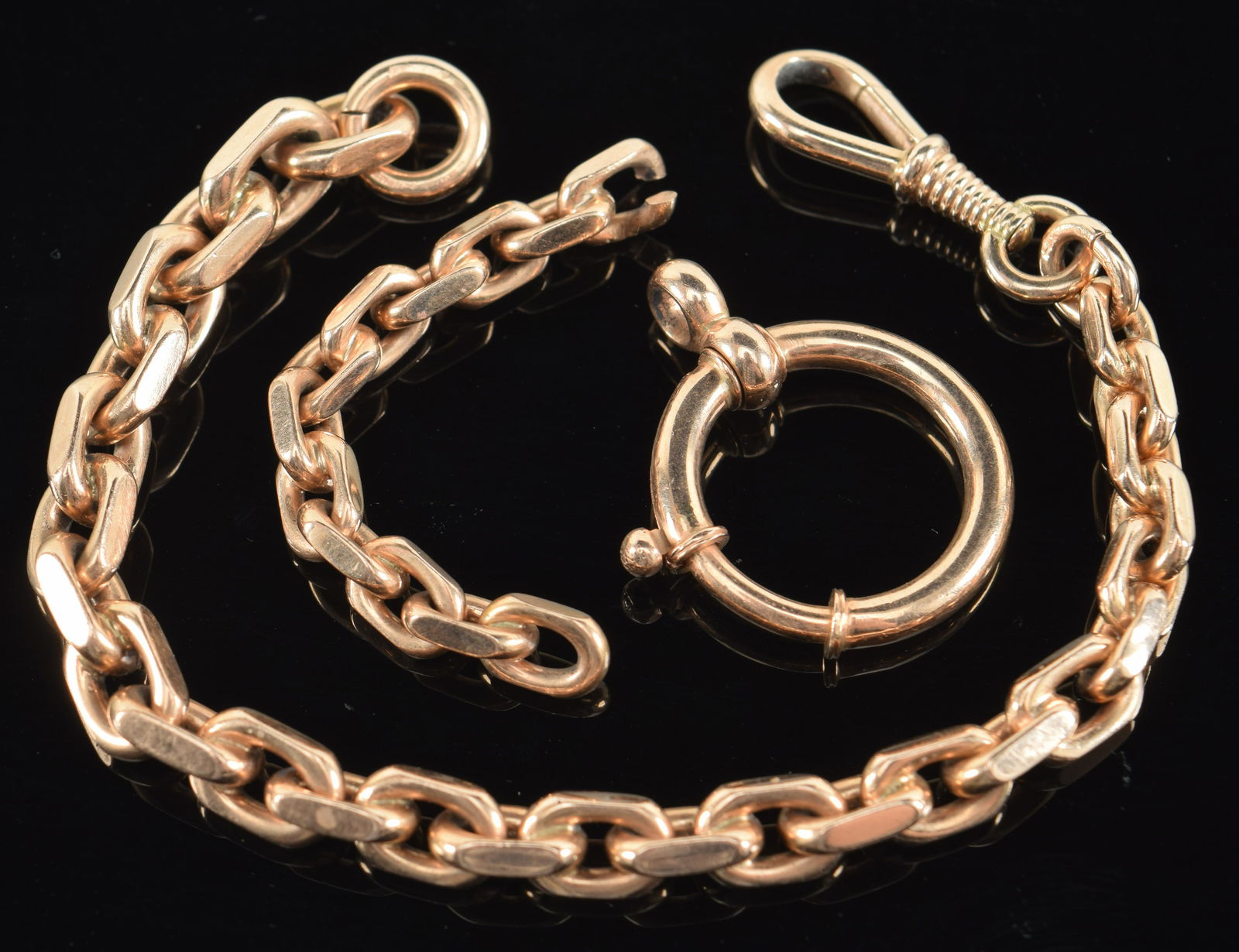 14K gold heavy watch chain. Interlock links. Shorter piece of chain included. Large round loop: 14K gold heavy watch chain. Interlock links. Shorter piece of chain included. Large round loop included. Marked .585 on small round link clasp. Chain 7.5in length without extra pieces. 55 grams total.