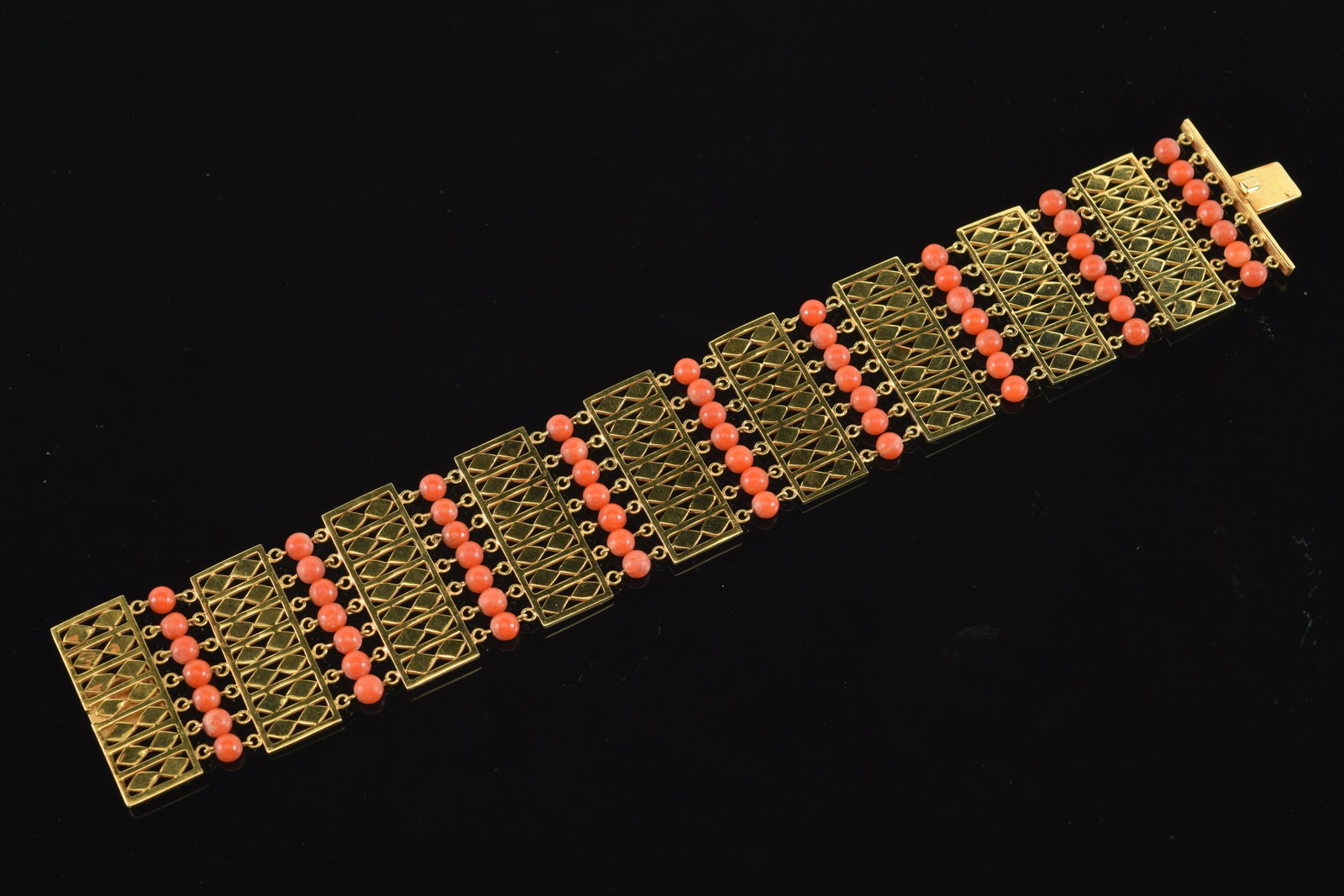 14K gold coral mounted bracelet. Several beads disconnected. Unmarked. Tests as 14K. 40.5 grams: 14K gold coral mounted bracelet. Several beads disconnected. Unmarked. Tests as 14K. 40.5 grams total weight. 7.5in long without clasp.
