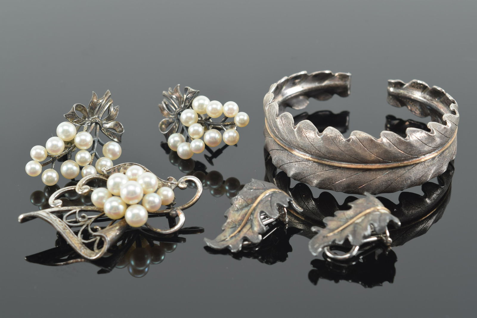 5 piece lot. 1) Buccellati silver and gold leaf form bracelet and earrings. Gold line across middle. (1 of 10)
