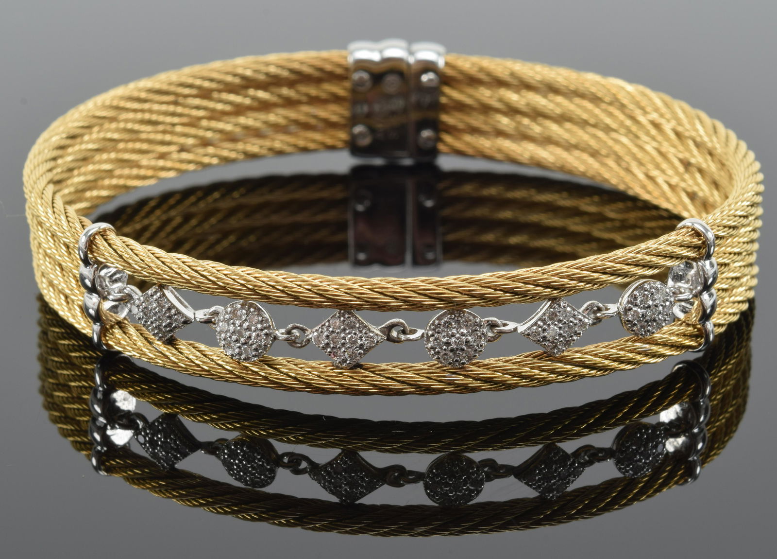 Charriol 18K white gold and diamond bracelet. Spring form with four plated yellow gold bands,: Charriol 18K white gold and diamond bracelet. Spring form with four plated yellow gold bands, open center with six diamond set medallions, in the original box. White gold insert marked 750. This descr