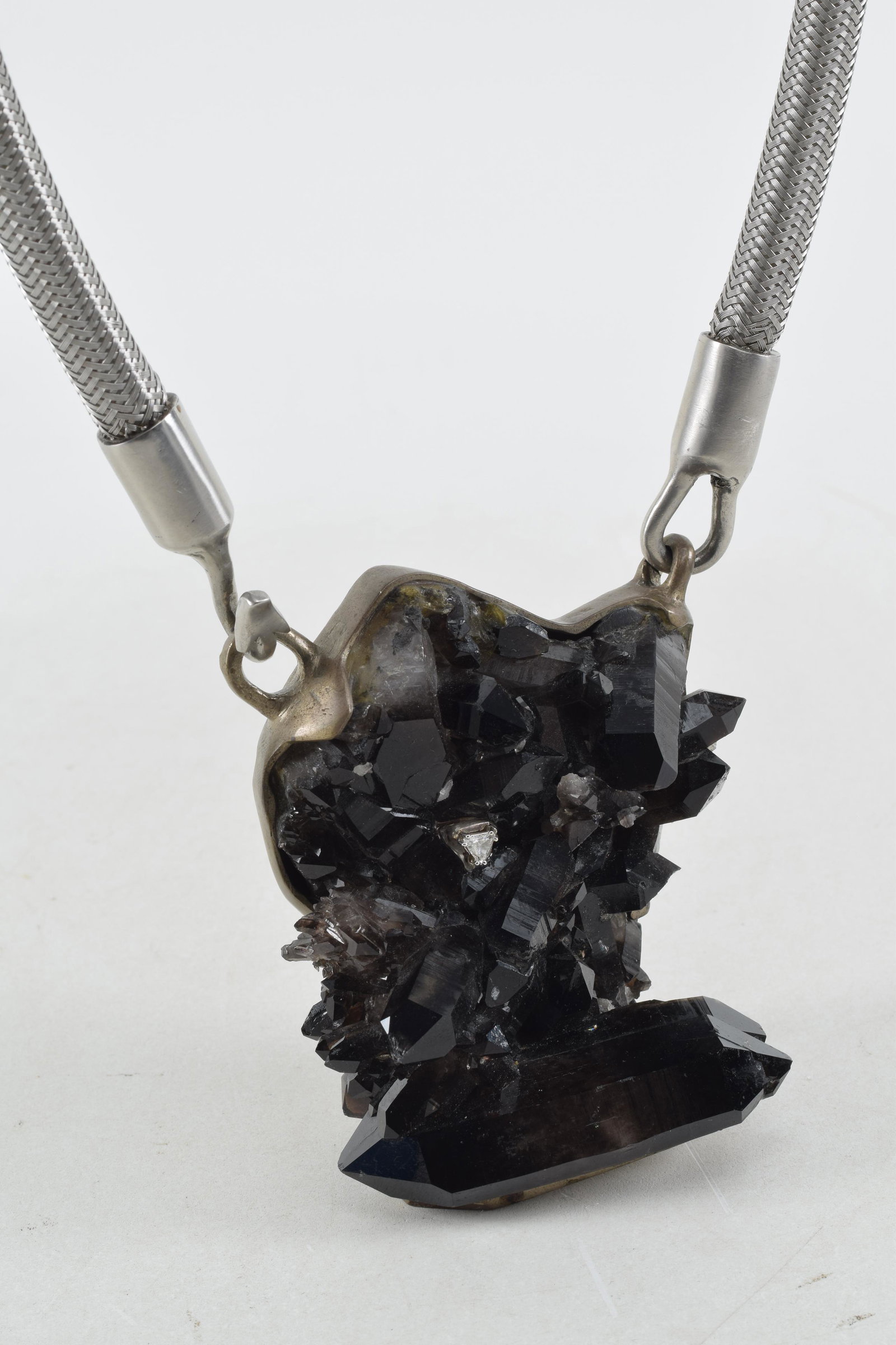 Abraxas Rex. Large diamond mounted necklace. Black and clear mineral specimen with trillion cut: Abraxas Rex. Large diamond mounted necklace. Black and clear mineral specimen with trillion cut diamond mounted specimen. Diamond sides approx. 4.3 mm each. Metal mounts. Signed on reverse. 14in long 