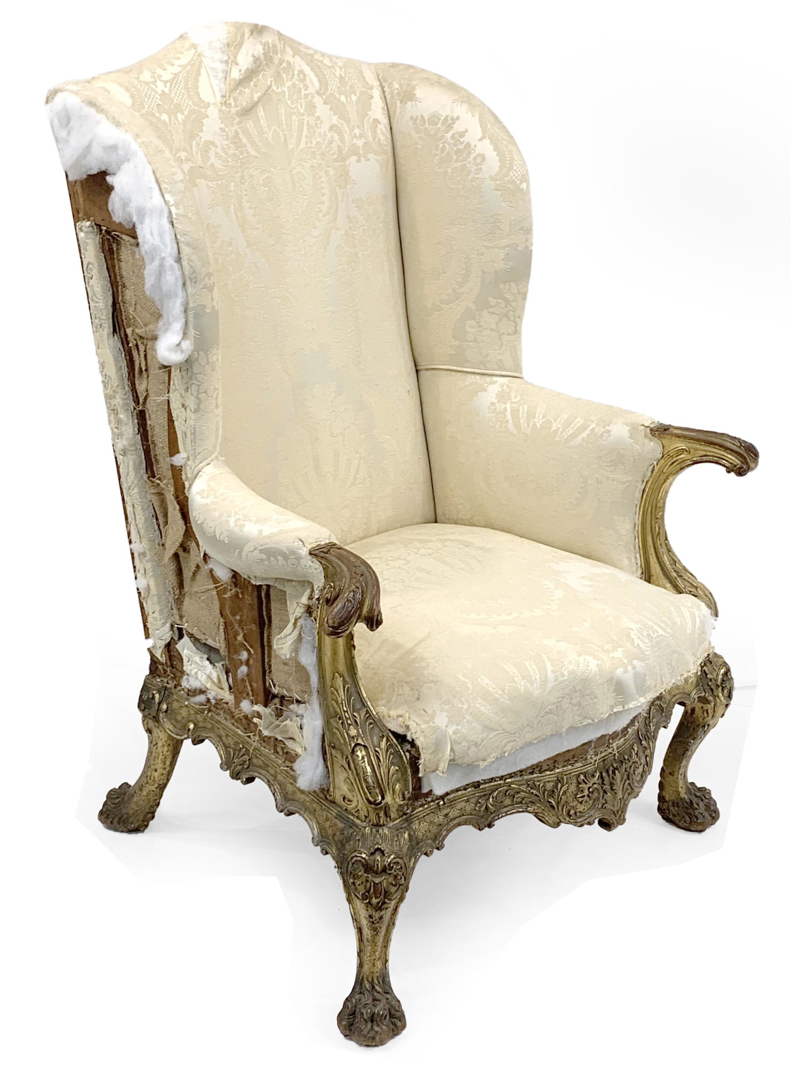 Fine Philadelphia Chippendale carved and gilt easy chair. 19th Century or earlier. Well carved: Fine Philadelphia Chippendale carved and gilt easy chair. Well carved hand holds and aprons with hairy paw feet. Warm color to gilding with areas of wear, repair to right rear leg. Carving in the mann